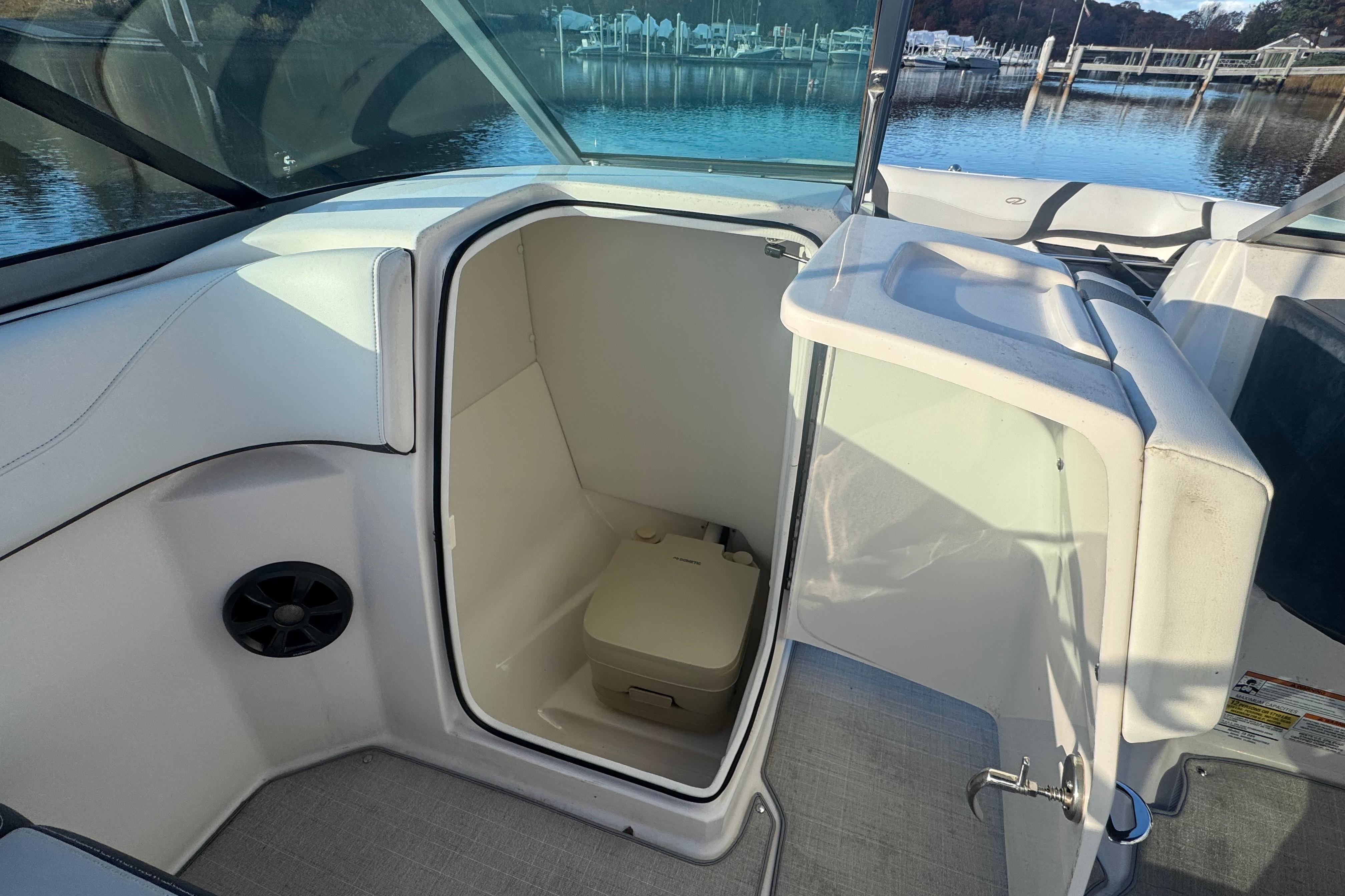 2017 Regal 23 OBX boat interior with open compartment and portable toilet.
