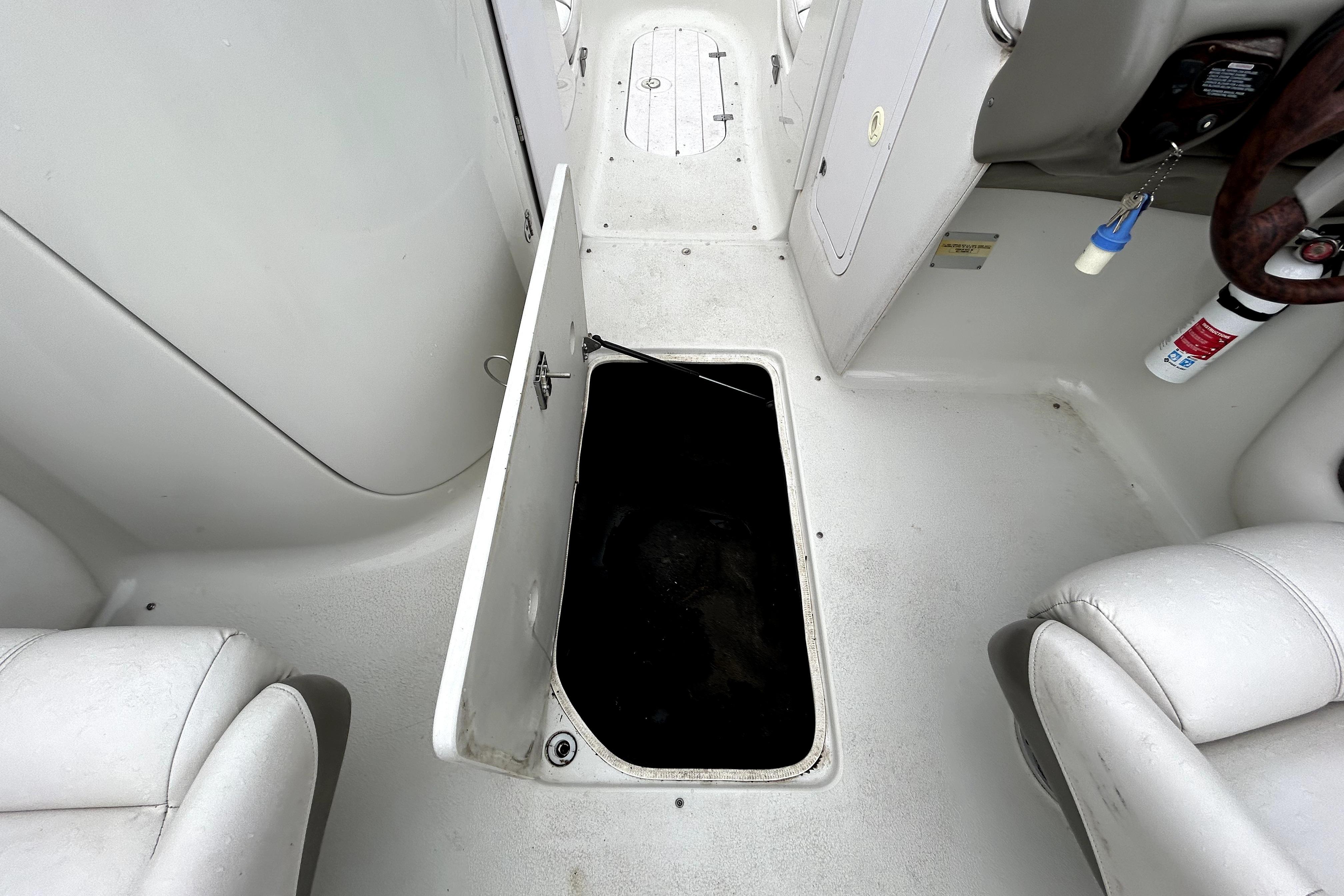 Open storage compartment on 2001 Crownline 239 DB boat interior.