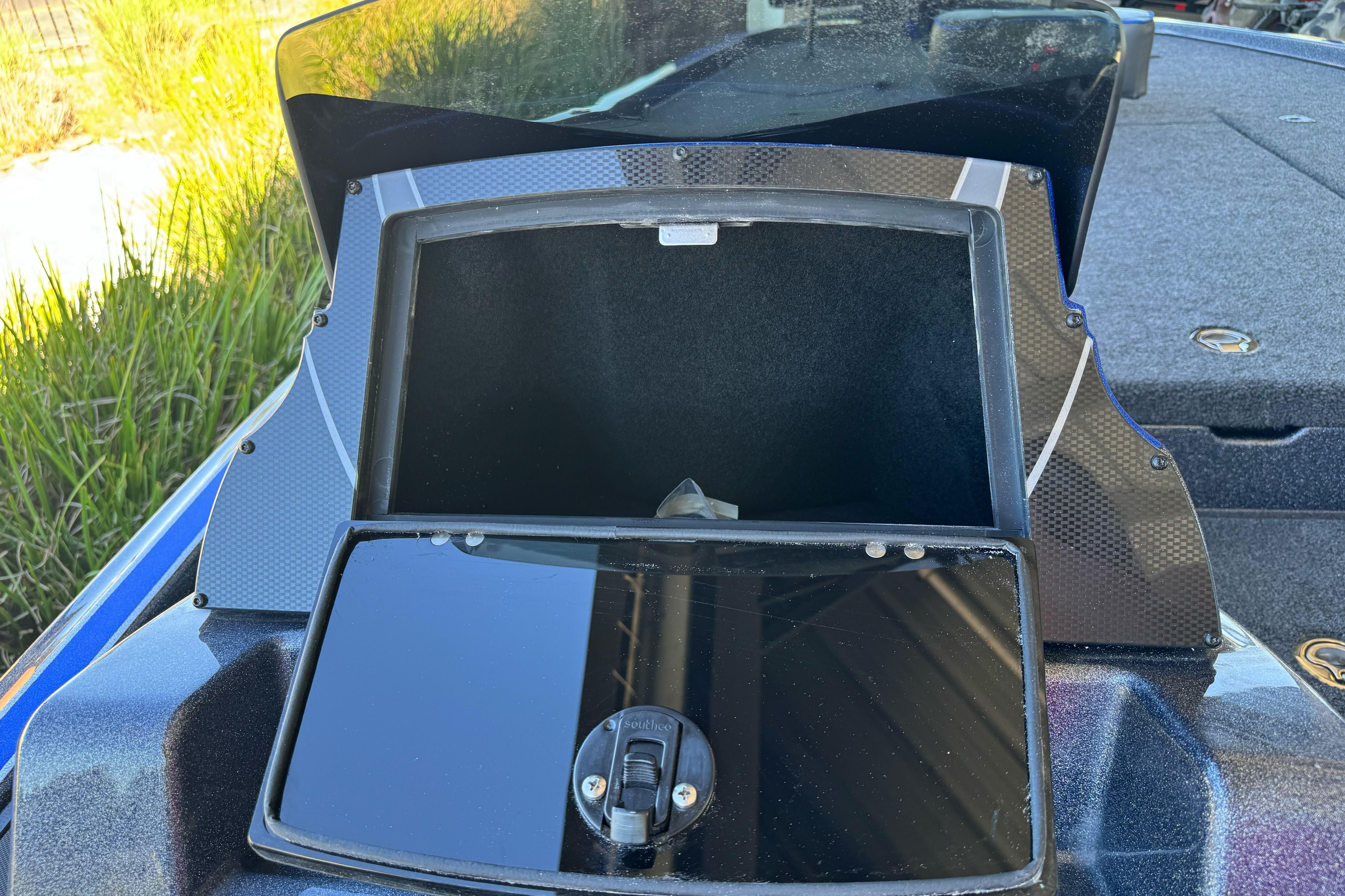 Open storage compartment on 2026 Triton 21XP Patriot boat, featuring sleek design and modern materials.