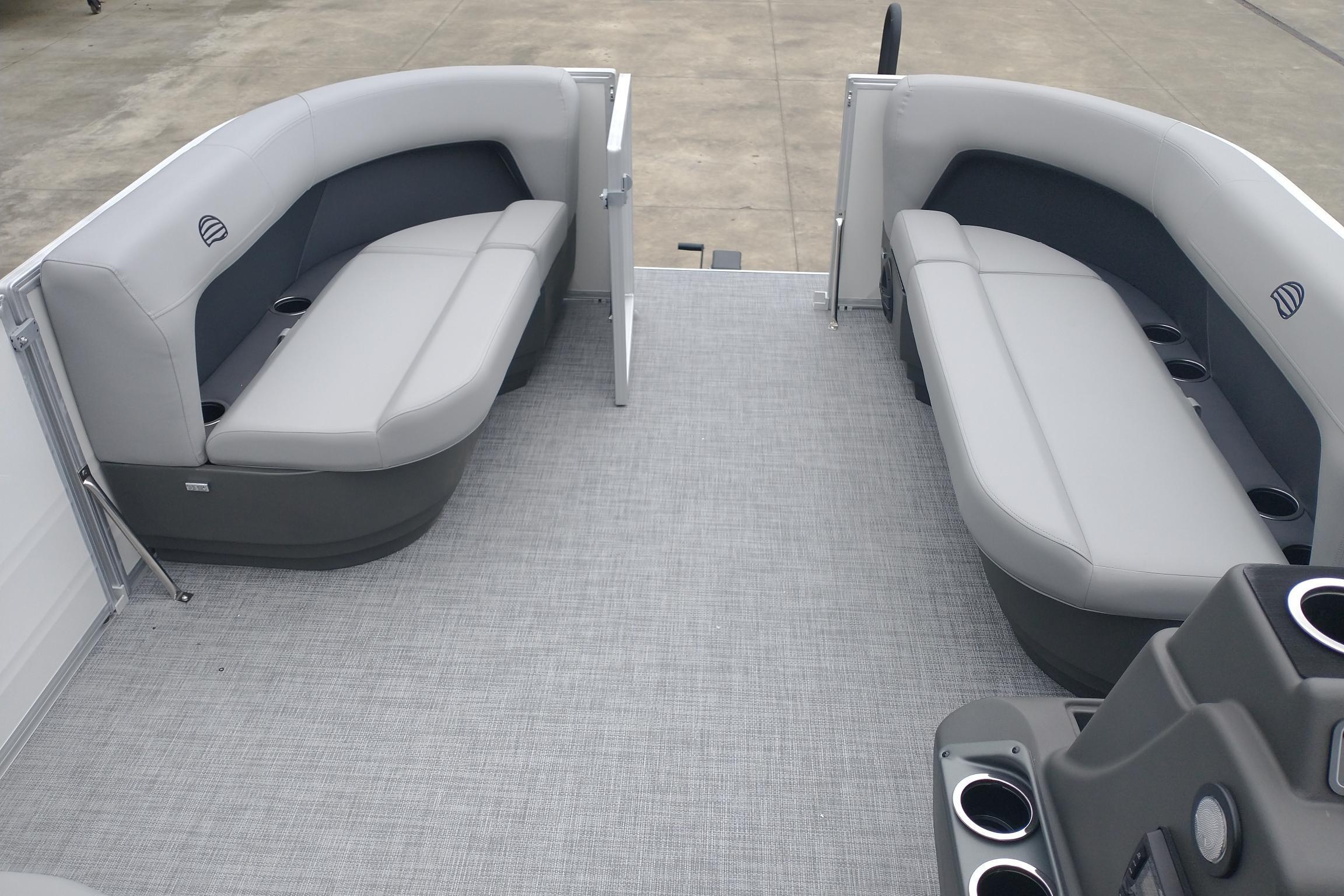 2026 Sun Tracker Party Barge 16 DLX interior with gray seating and cup holders.
