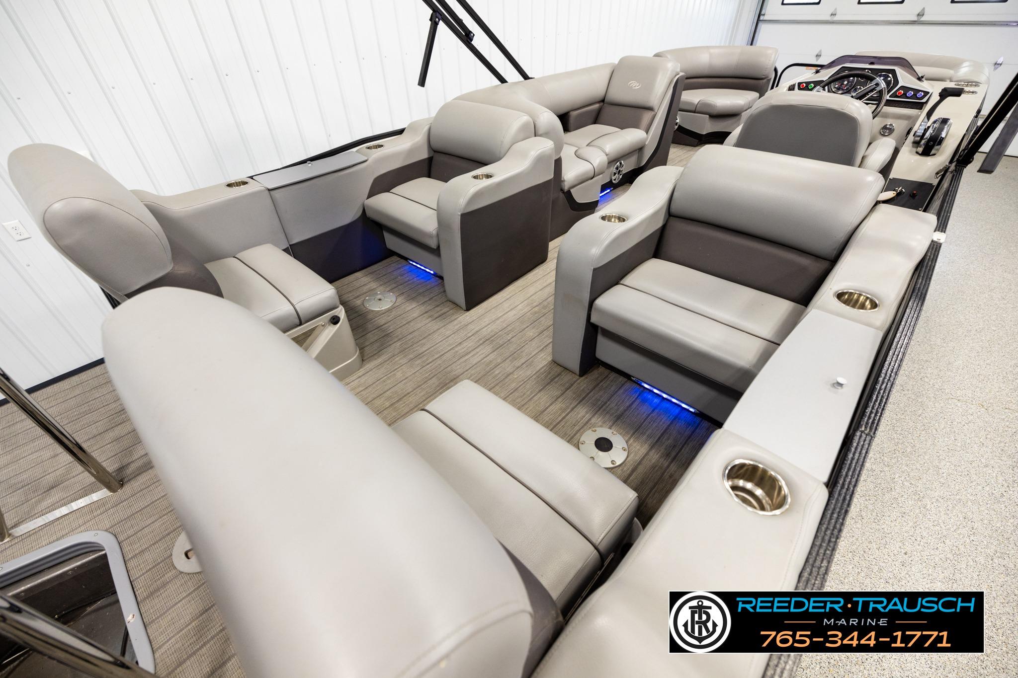 2019 Manitou Oasis SR VP pontoon boat interior with plush seating and modern dashboard.