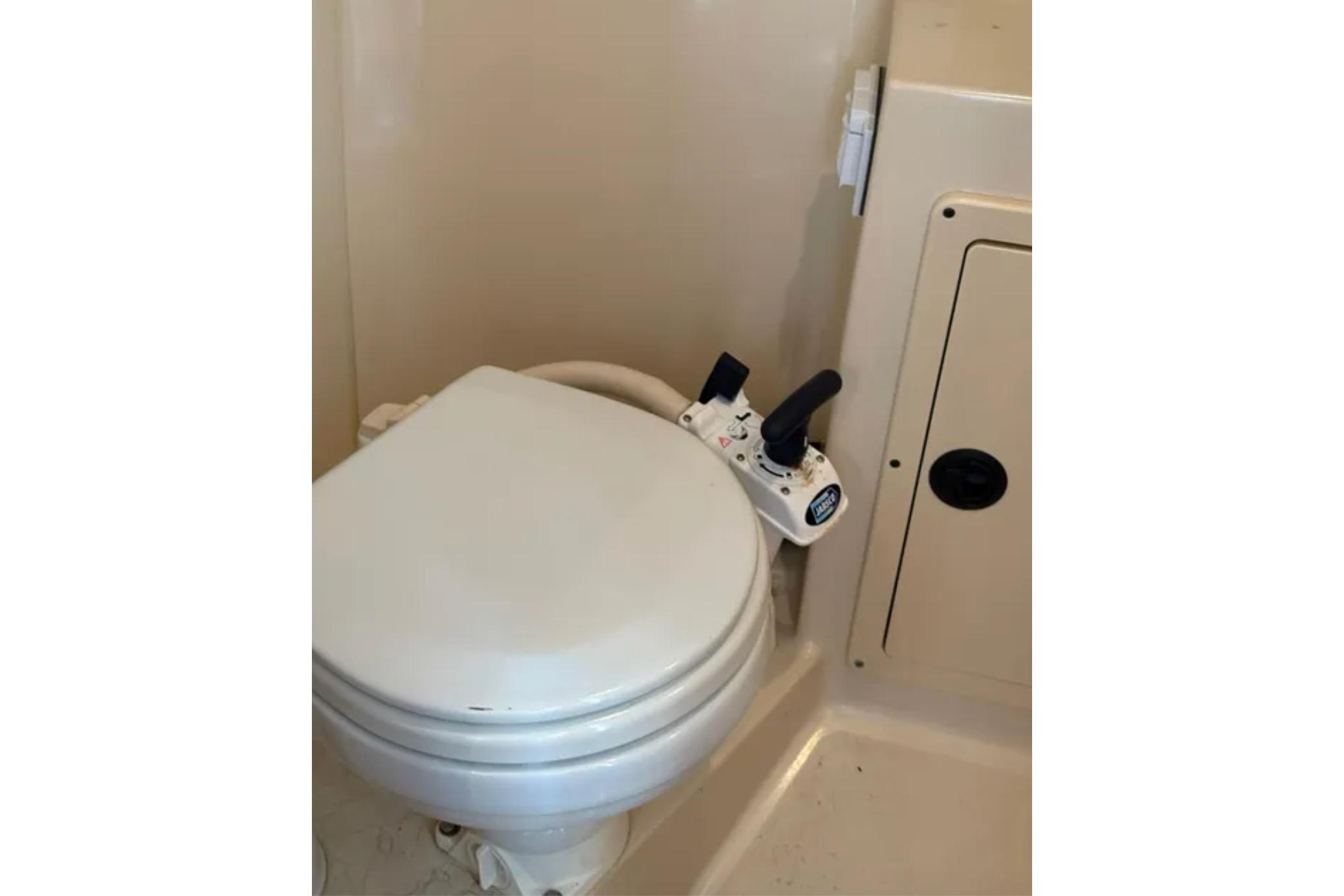 Marine toilet in 2005 Albin 28 Tournament Express boat bathroom.