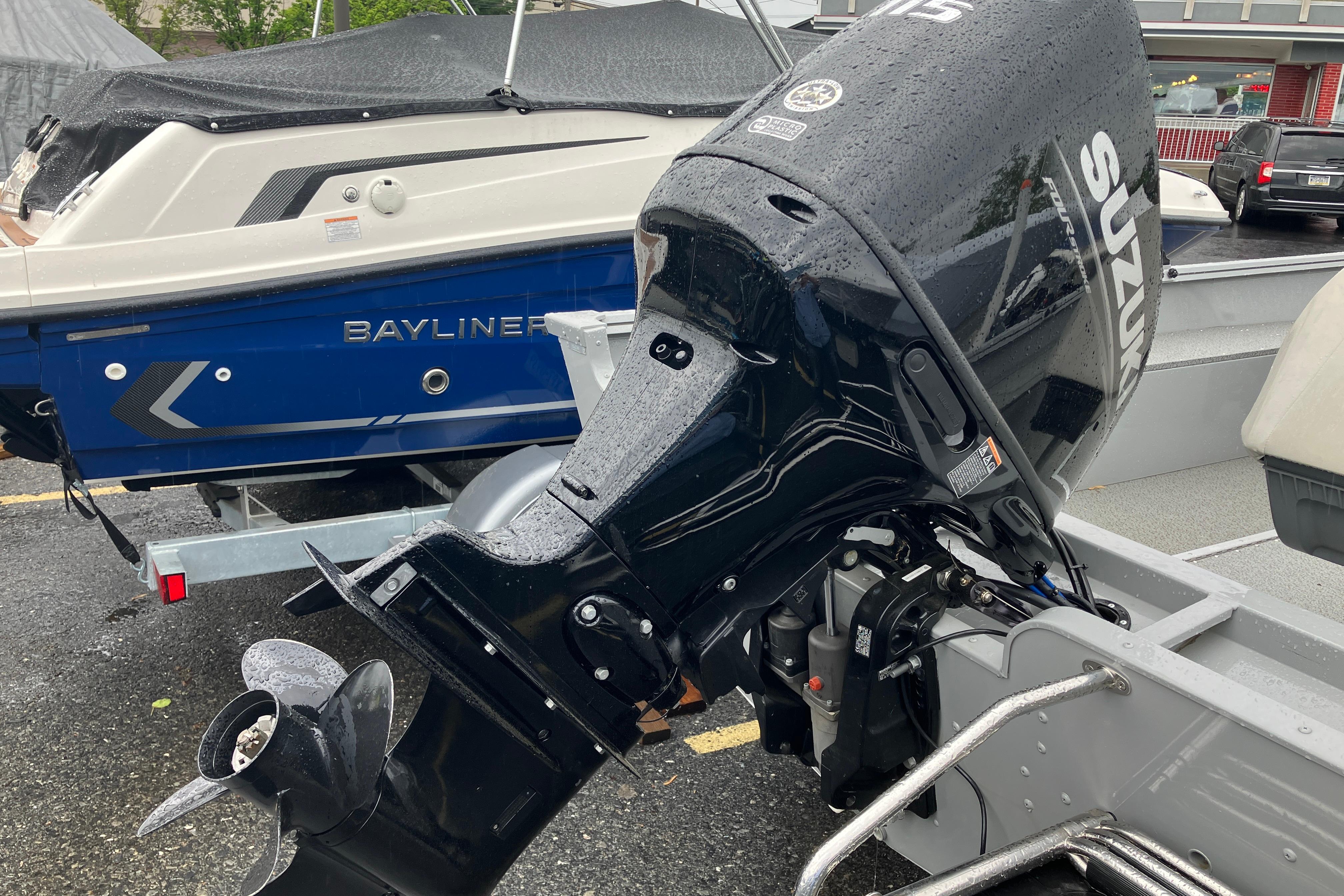 2024 Smoker Craft Freedom 180 CC with Suzuki outboard motor in a parking lot.
