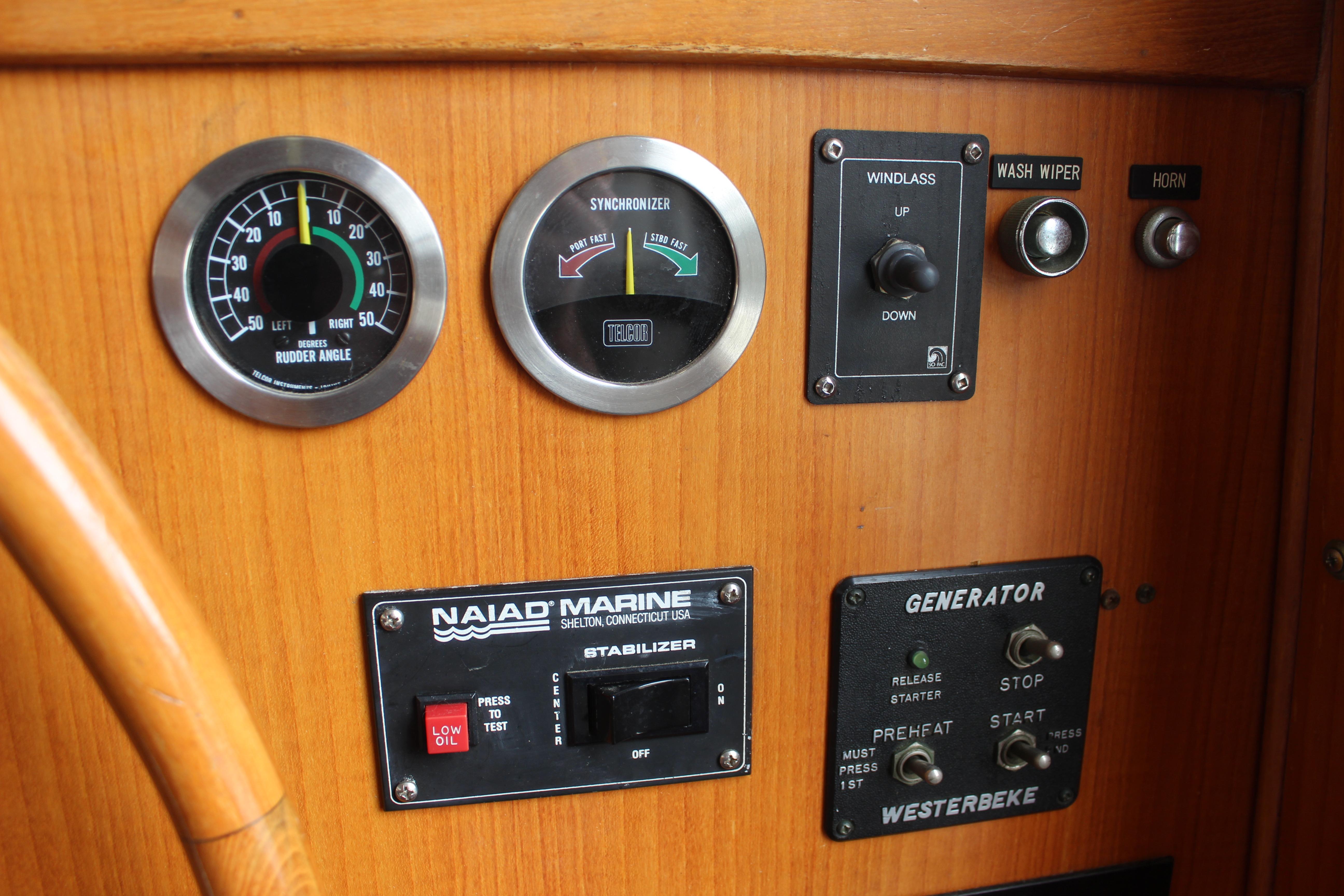 Control panel of a 1986 Kha Shing Spindrift 46 yacht with gauges and switches.