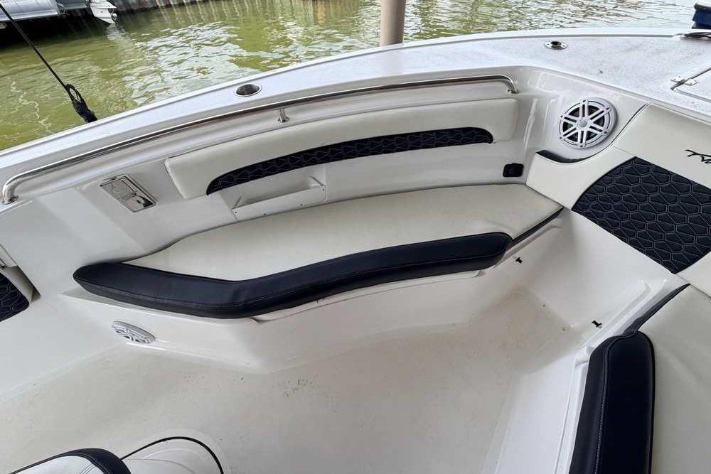 2024 Tidewater 232 LXF boat interior with cushioned seating and speaker.