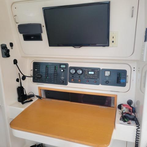 Control panel of a 2001 Voyage Maxim yacht with navigation equipment and display screen.