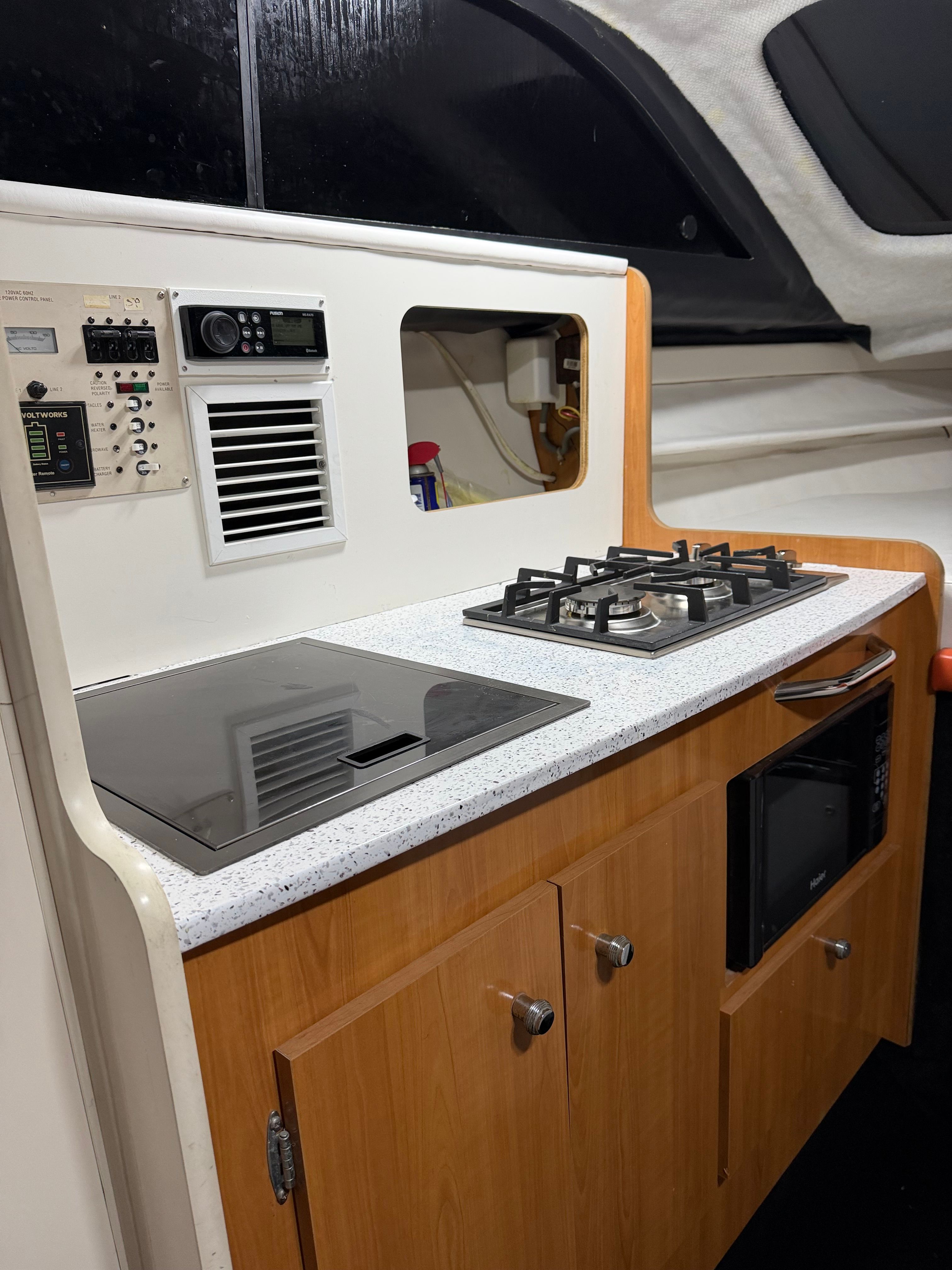 Interior view of a 2001 Bayliner 2452 Ciera Classic with stove and microwave.
