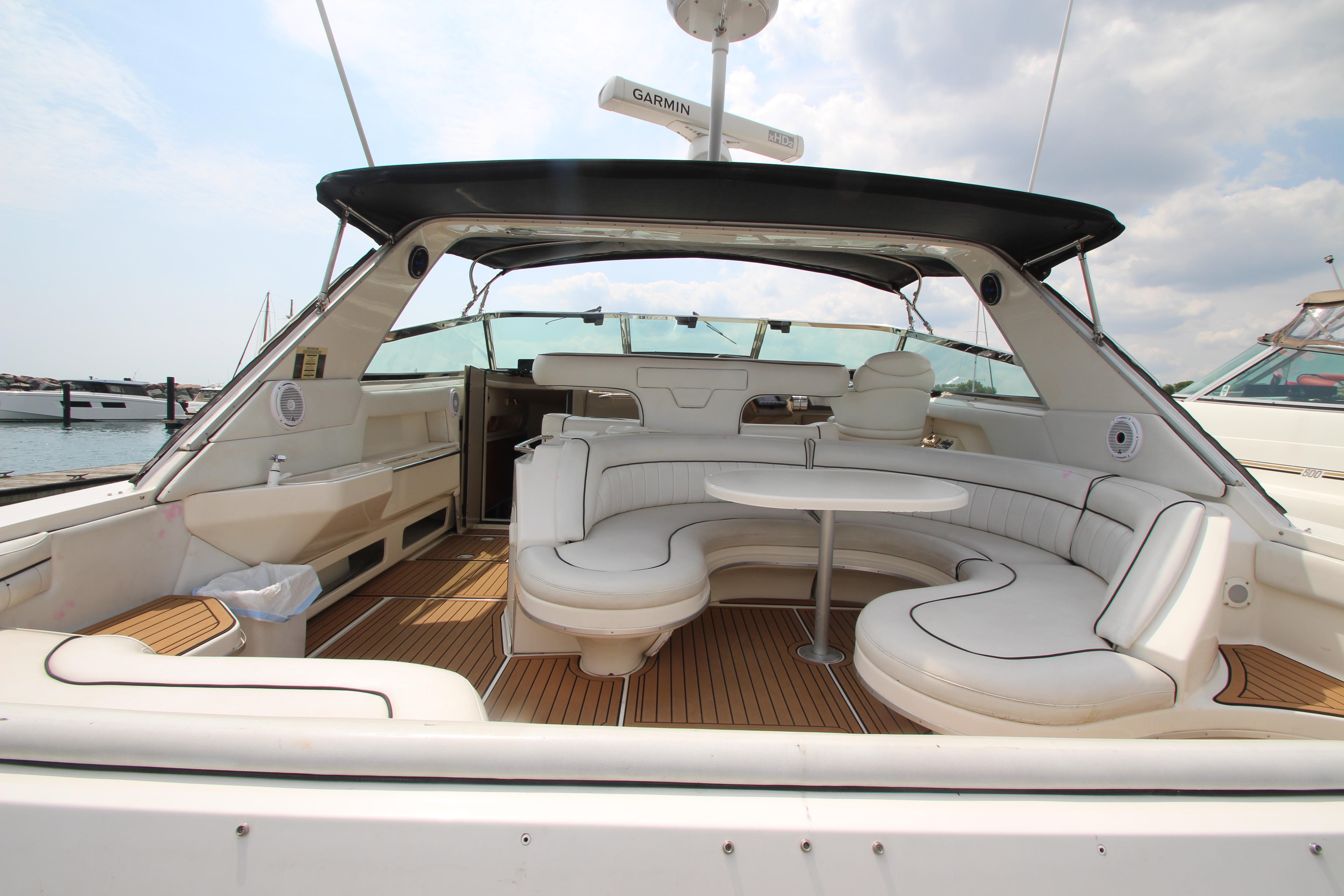 1998 Sea Ray 500 Sundancer yacht with spacious seating area and wooden deck.