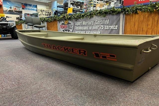2026 Tracker Grizzly 12 Jon boat displayed in a showroom with promotional banners.