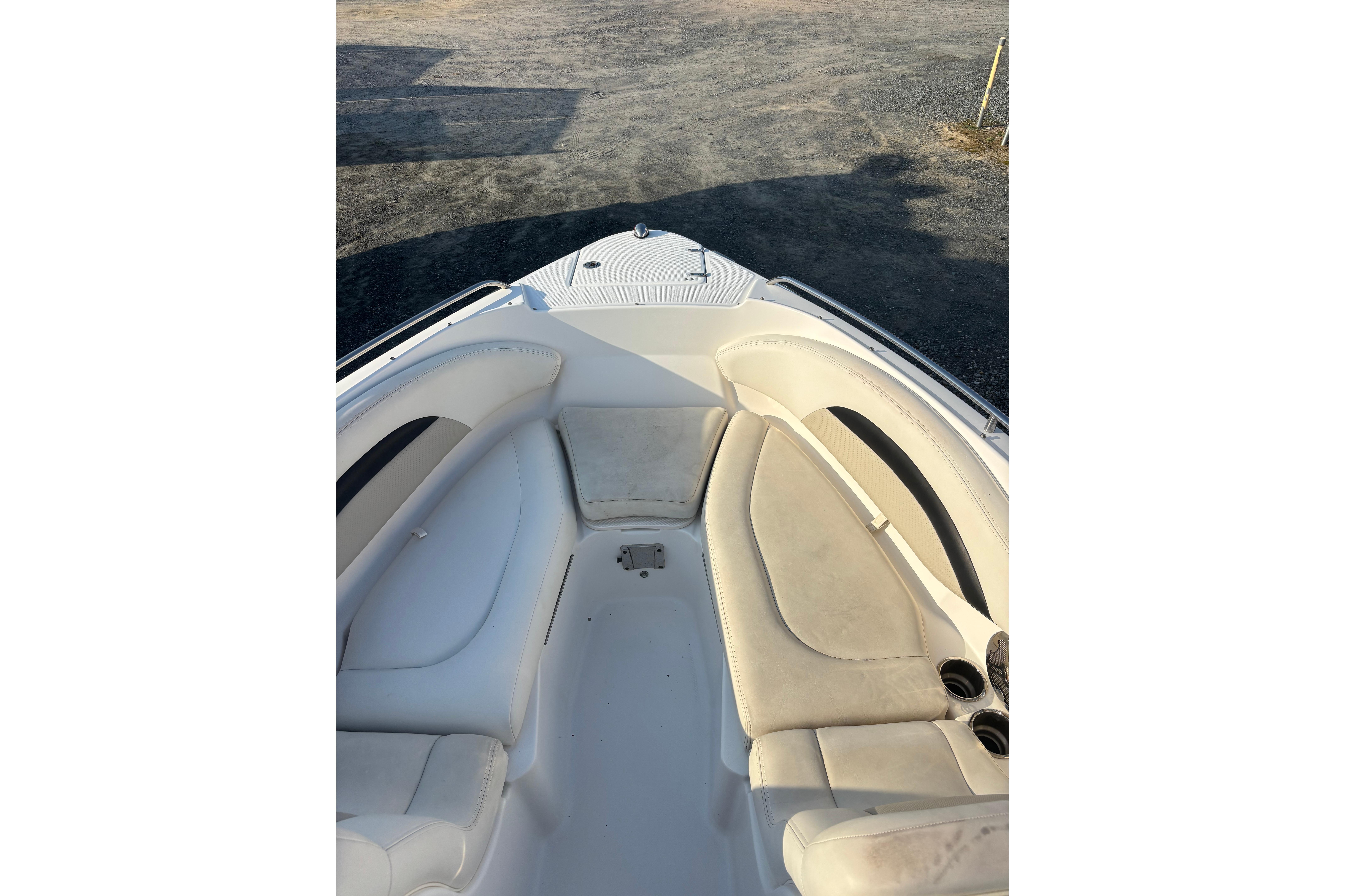 2012 Chaparral 267 SSX boat interior with white seating and cup holders.