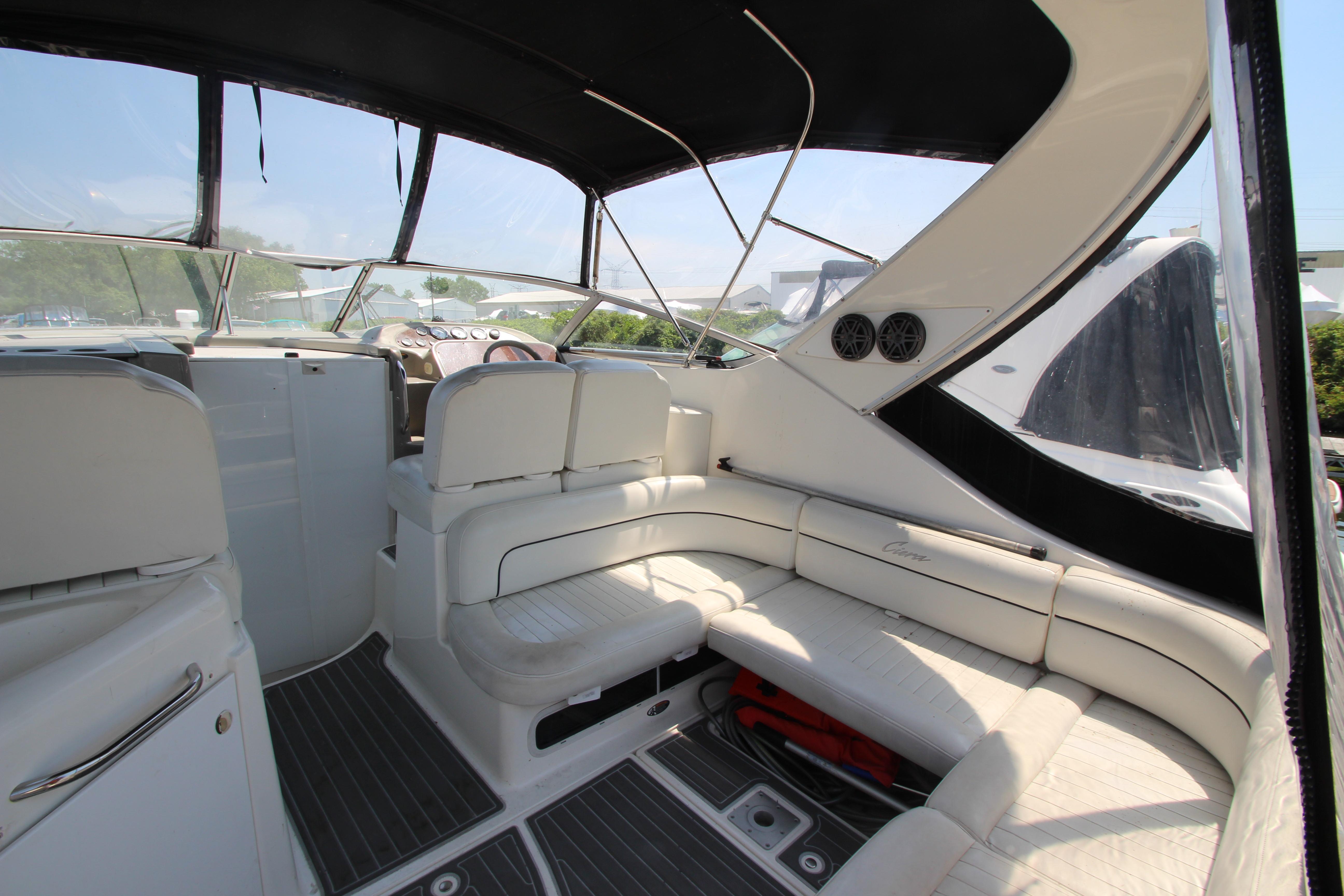 1999 Bayliner 3055 Ciera interior with white seating and black canopy.