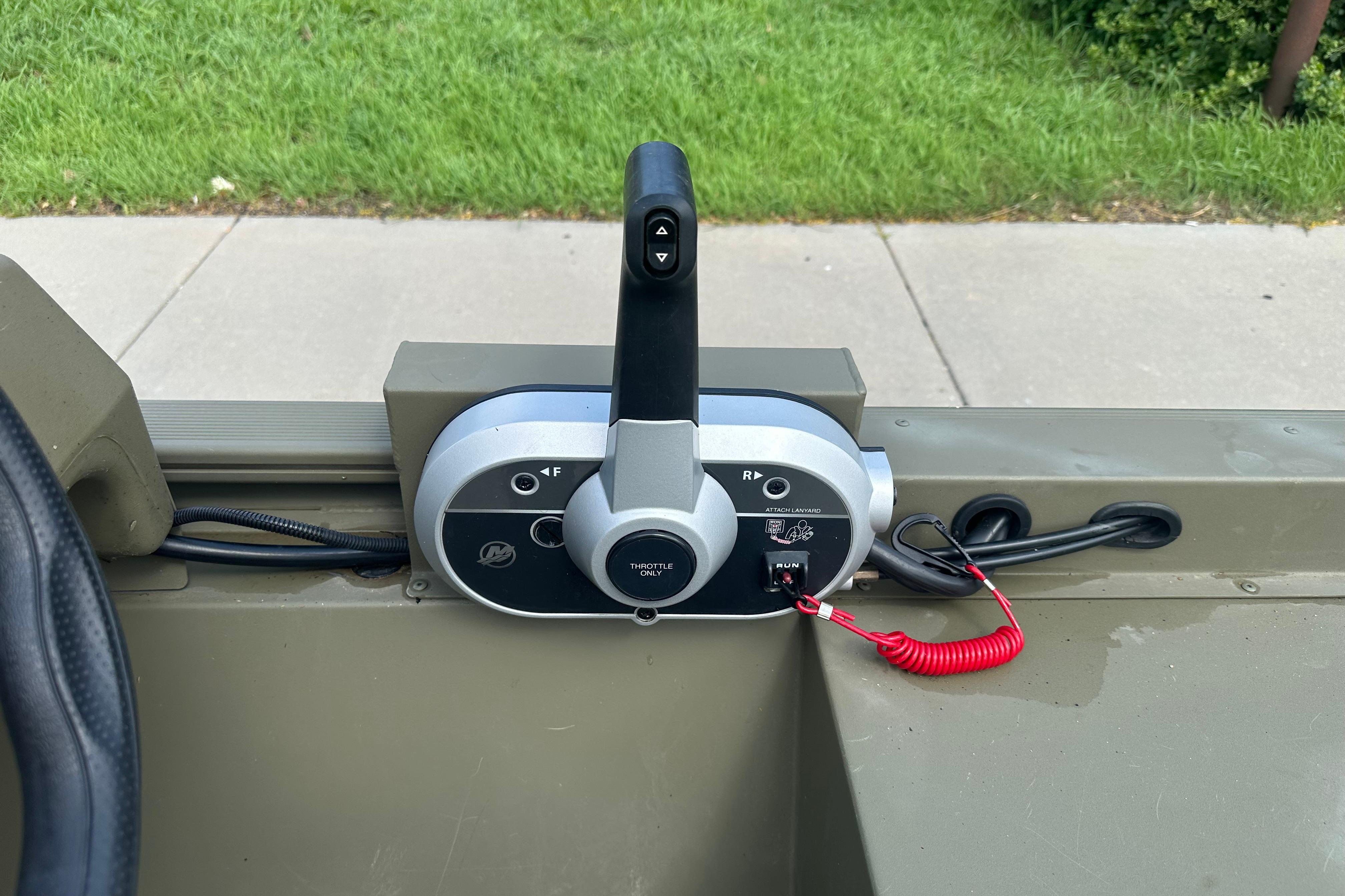 Throttle control panel of 2024 Tracker Grizzly 1648 SC boat, featuring a sleek design.