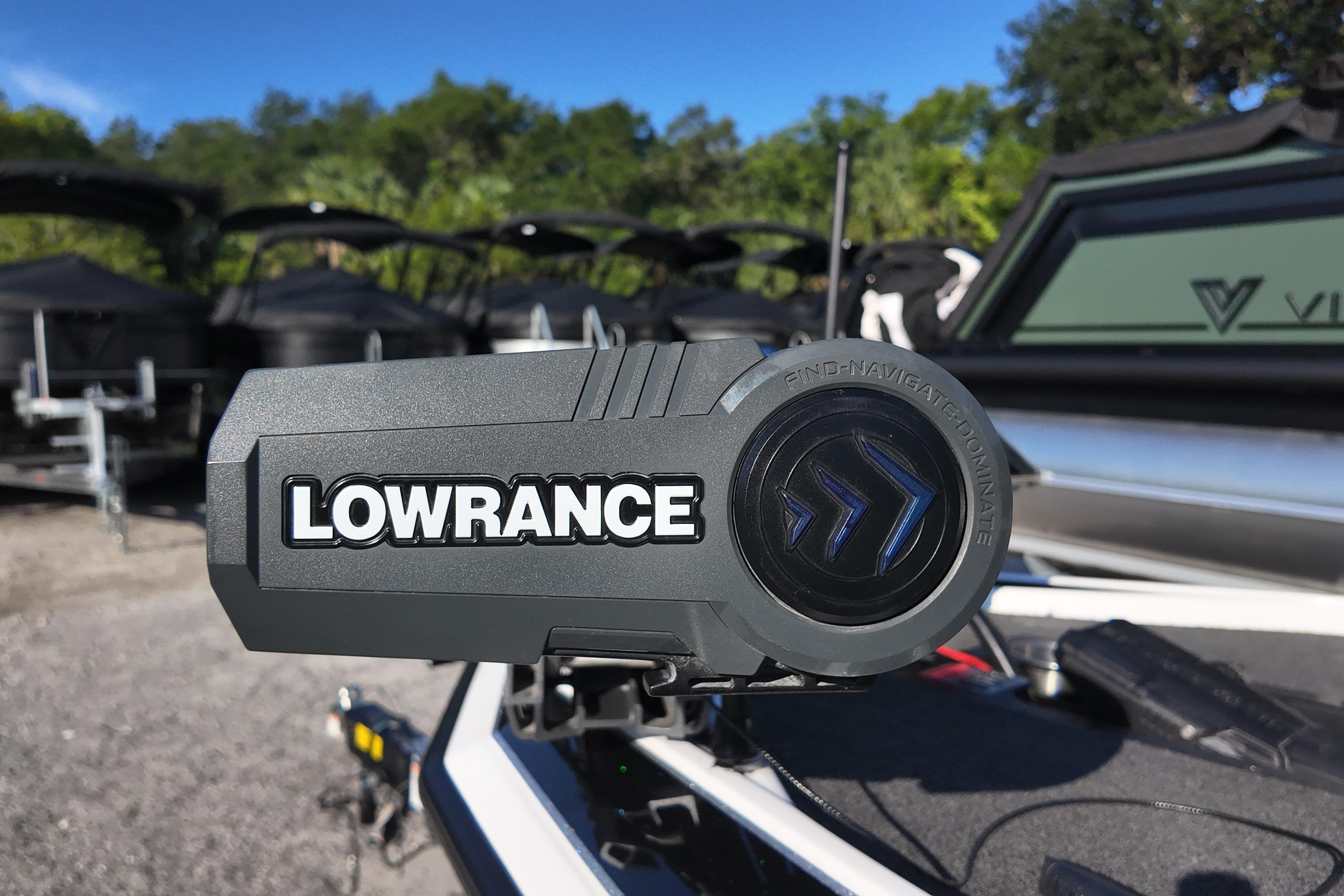 Lowrance device on 2022 Bullet 21SDC boat, surrounded by trailers and greenery.