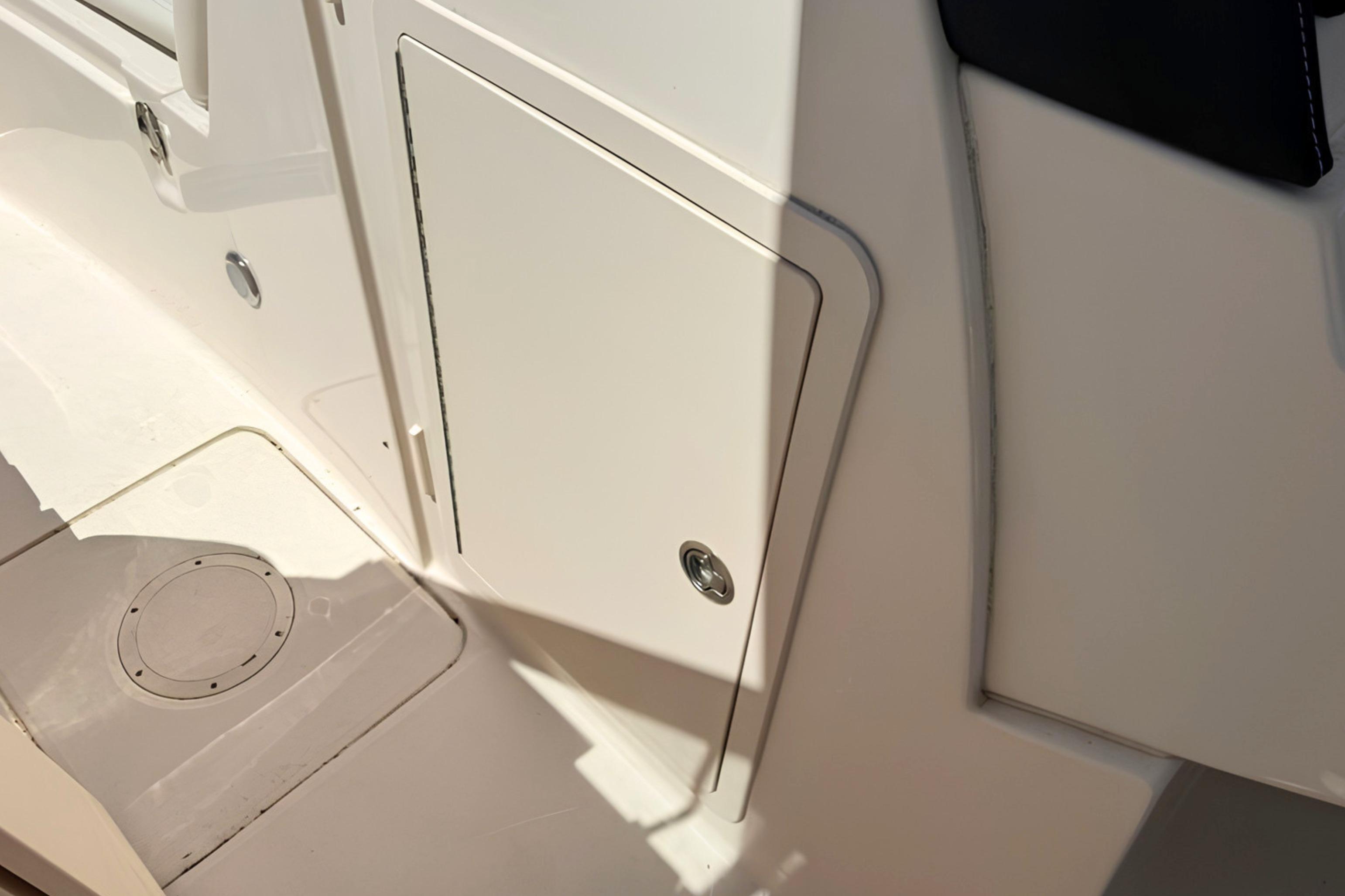 2017 Grady-White Freedom 235 boat interior, featuring a storage compartment and deck details.