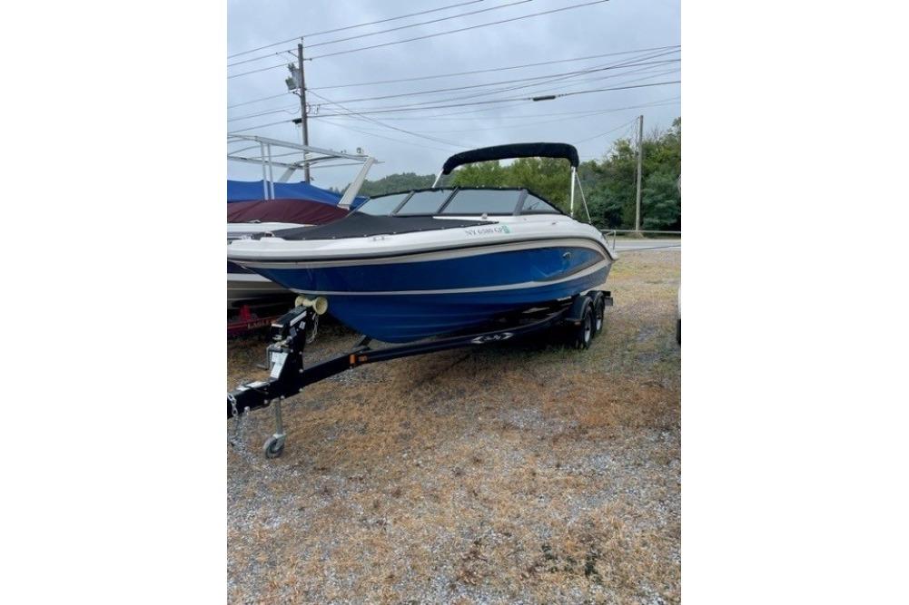 2015 Sea Ray 210 SLX boat on trailer, parked outdoors on gravel.