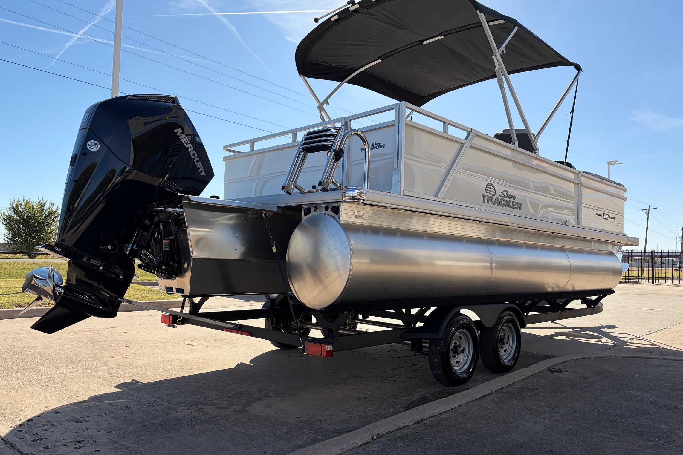 2026 Sun Tracker Party Barge 22 RF XP3 pontoon boat on trailer, featuring Mercury outboard motor.