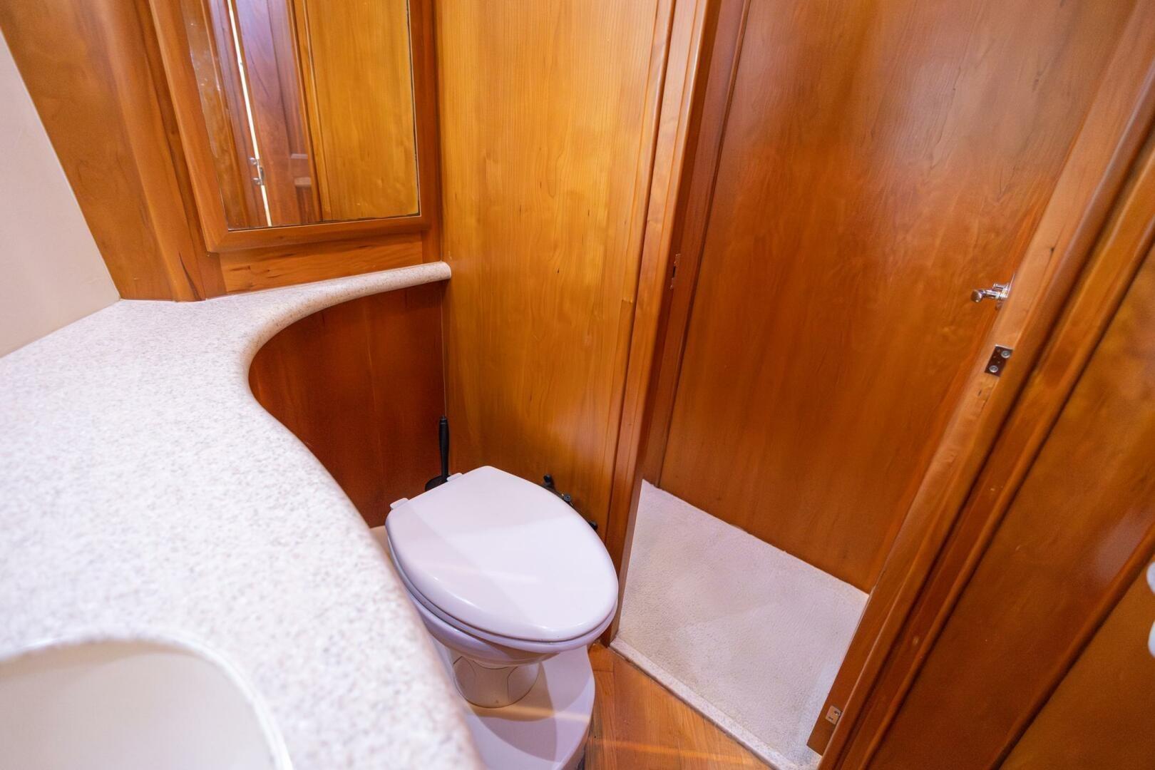 2001 Silverton 410 Sport Bridge bathroom with wooden cabinetry and modern fixtures.