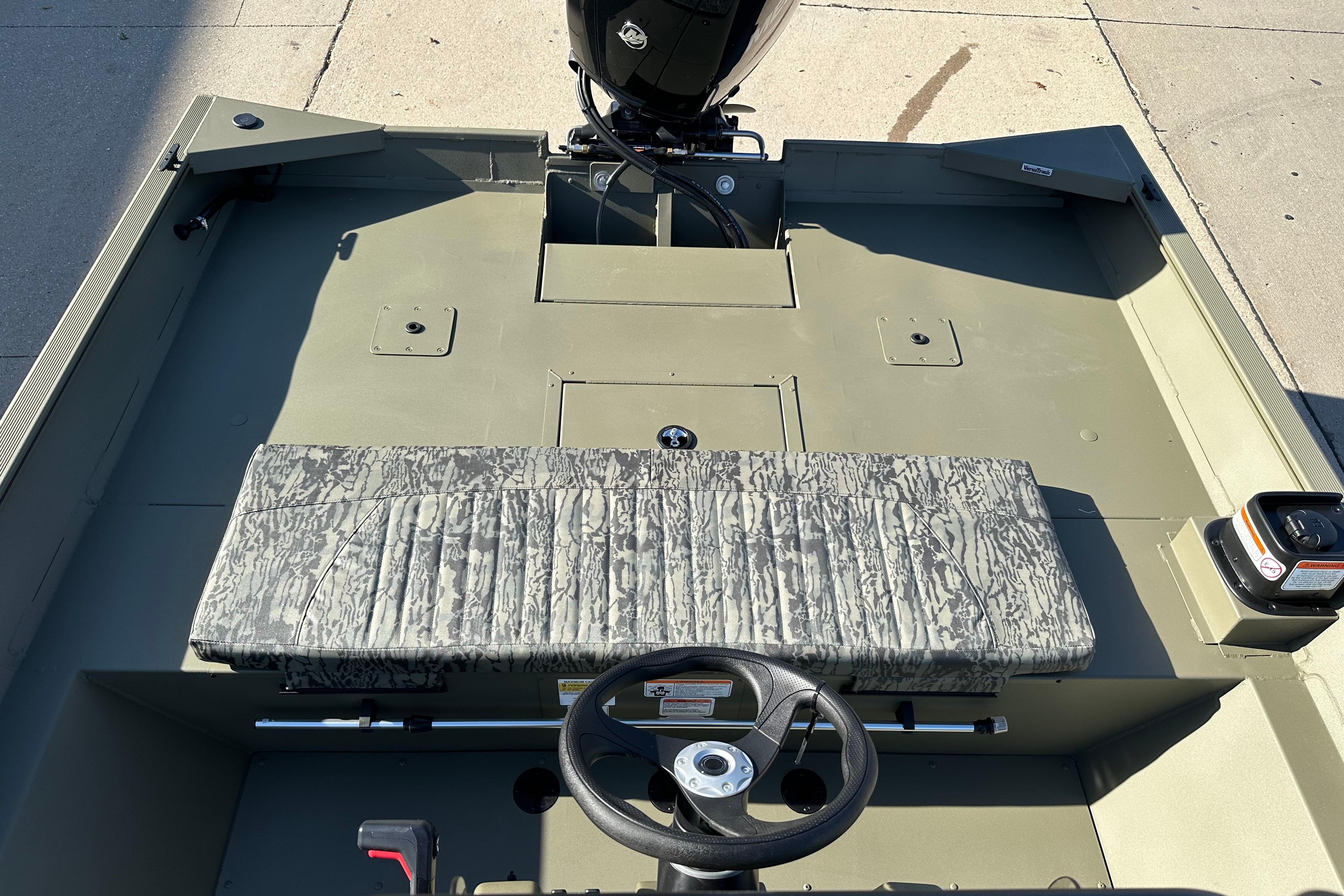2026 Tracker Grizzly 2072 CC boat interior with camouflage seating and steering wheel.