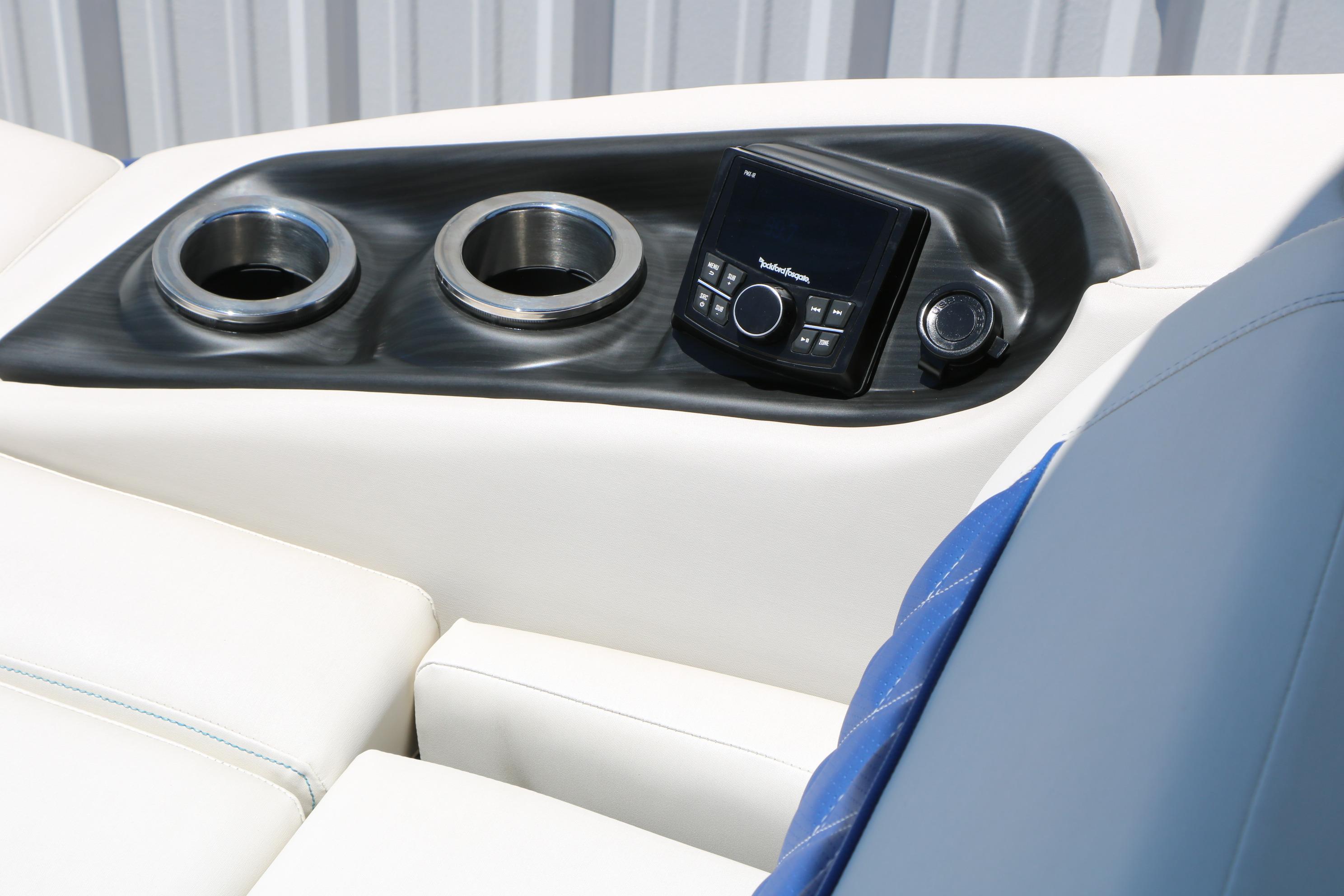 Interior of 2024 Bennington 23 RX Swingback with cup holders and control panel.