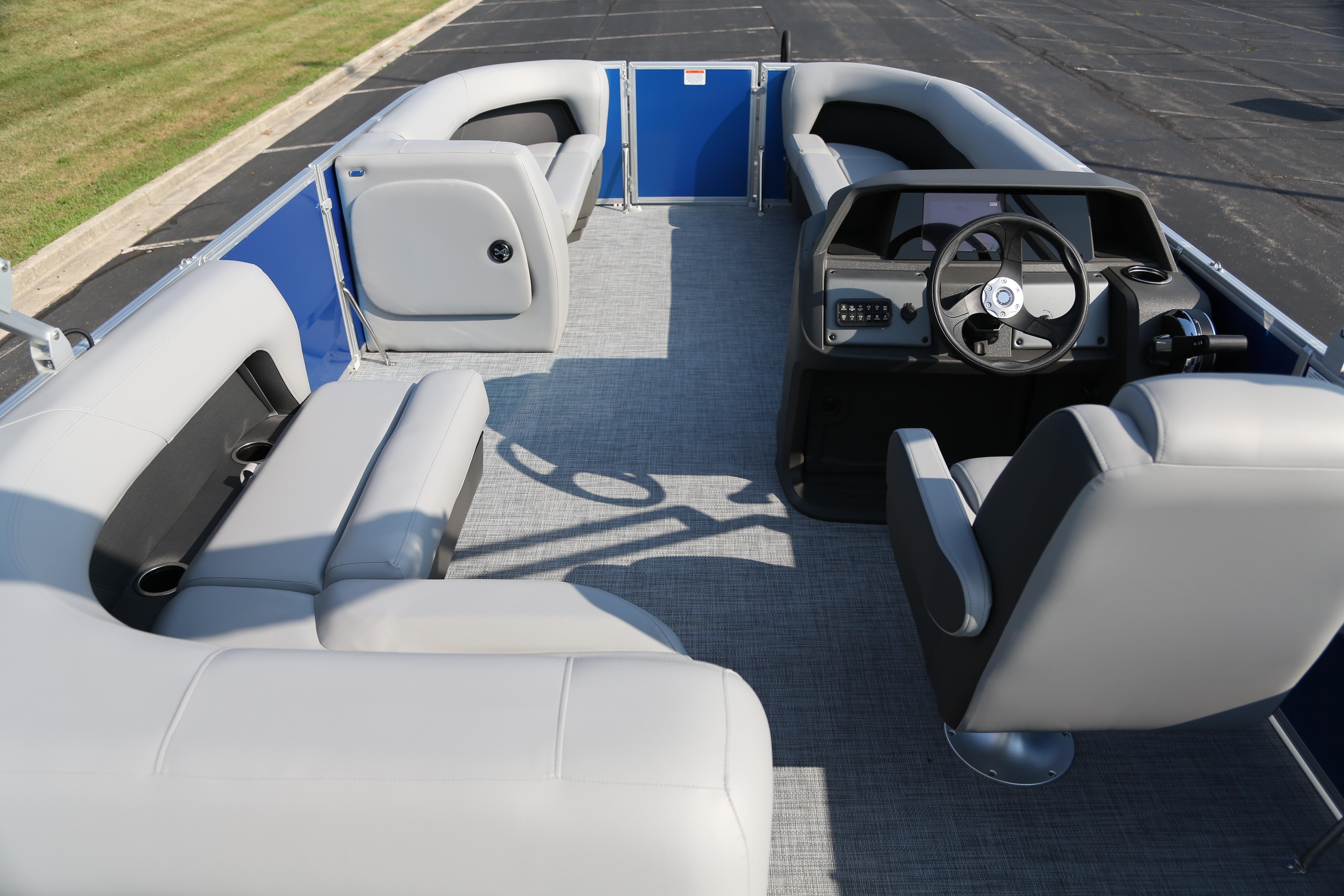 2026 Sun Tracker Party Barge 18 DLX interior with gray seating and steering console.