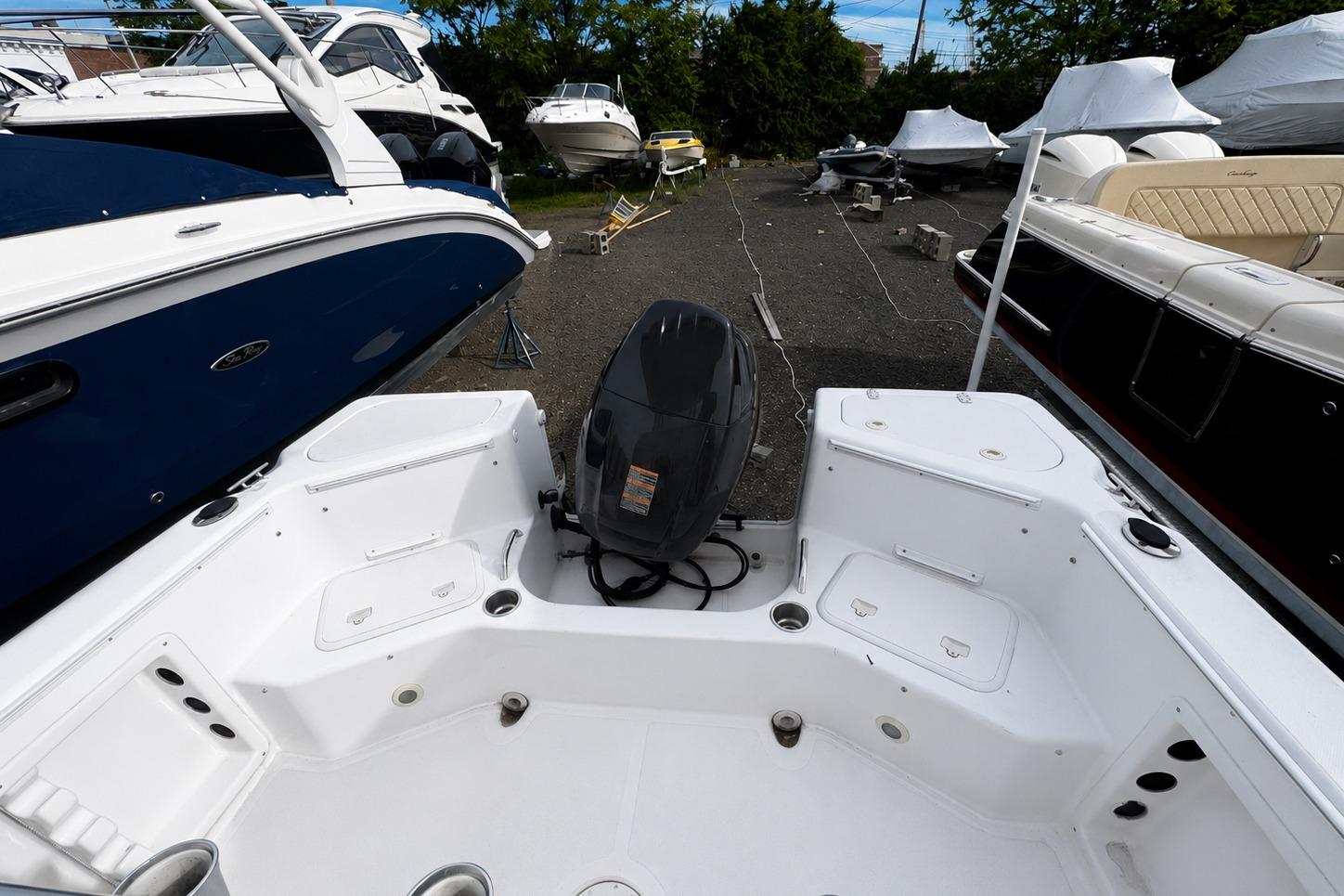 2008 PROLINE 20 Sport boat interior with motor, docked among other boats.