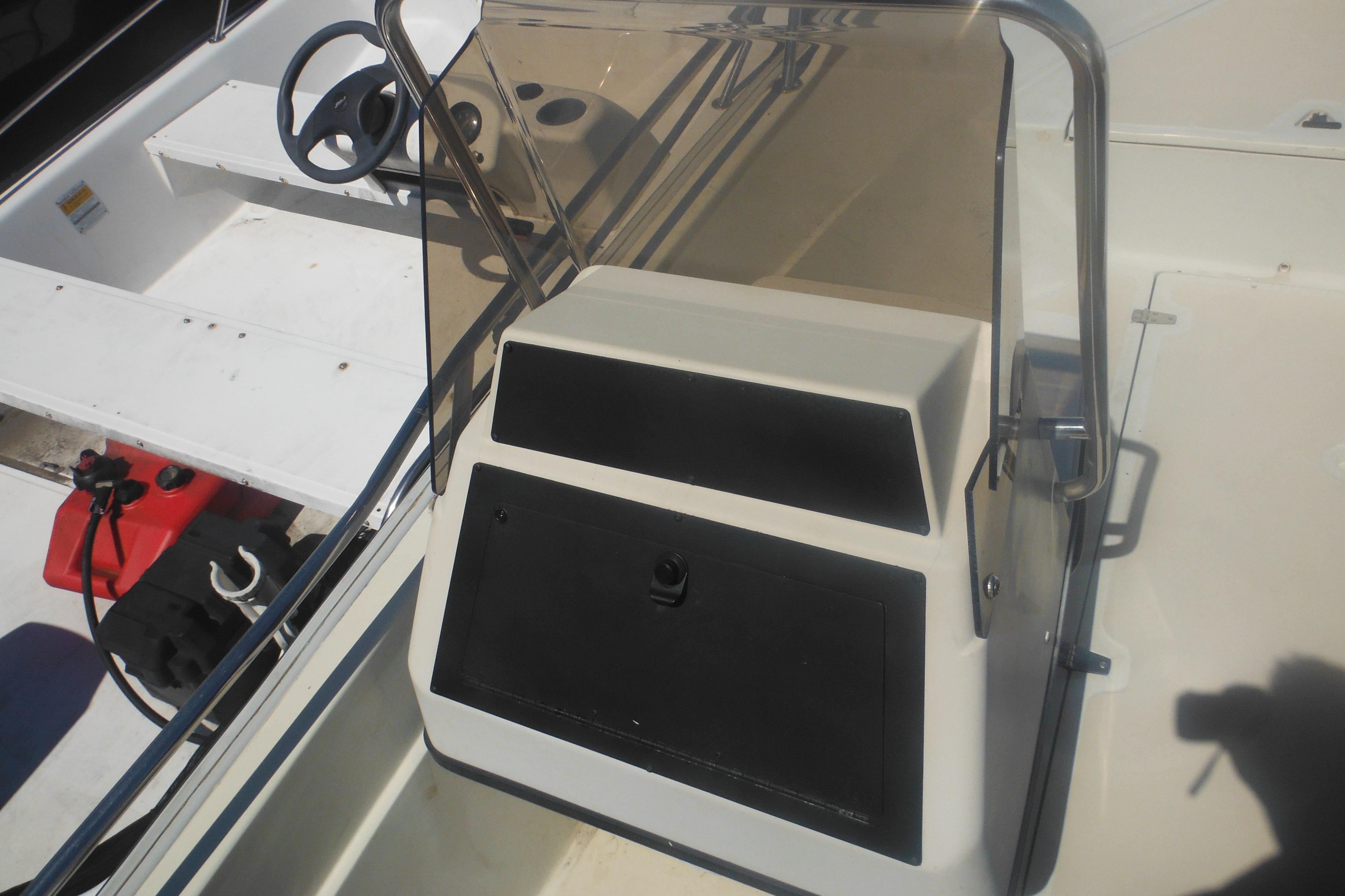 1991 Boston Whaler 16 SL boat interior with steering wheel and console.