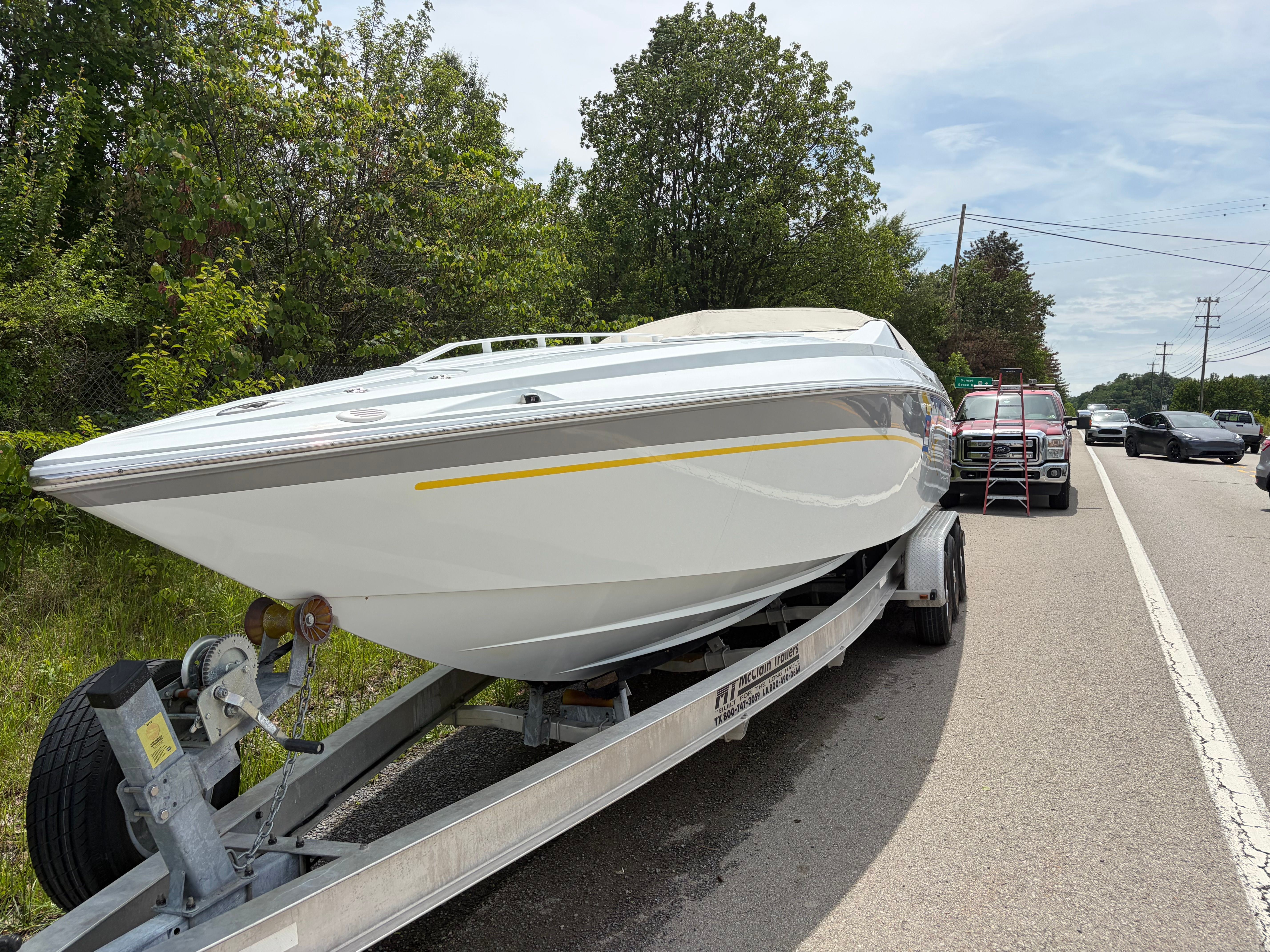 2007 Baja 30 Outlaw on trailer beside road.
