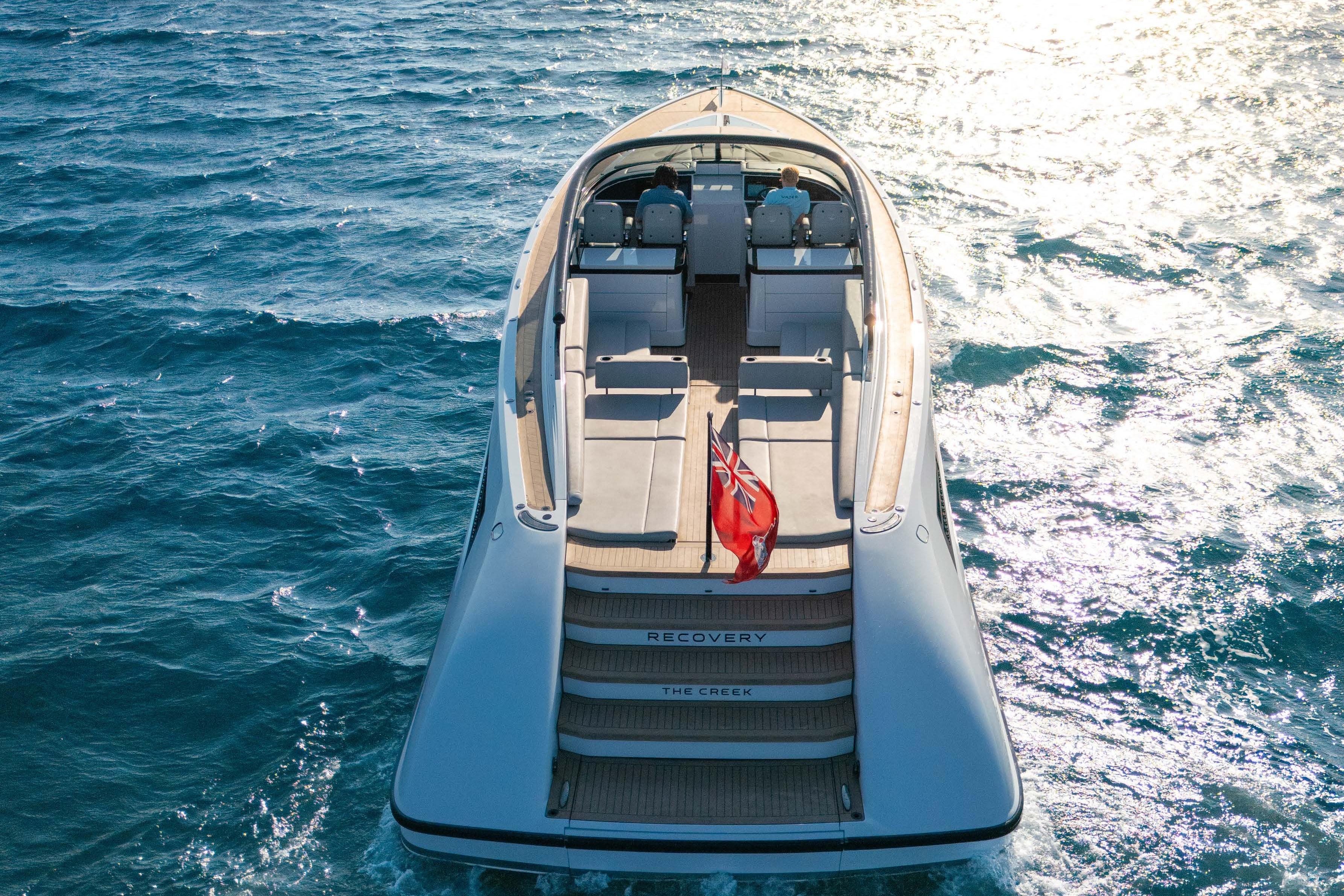 Luxury 2019 Wajer 55 yacht cruising on open sea with red flag.