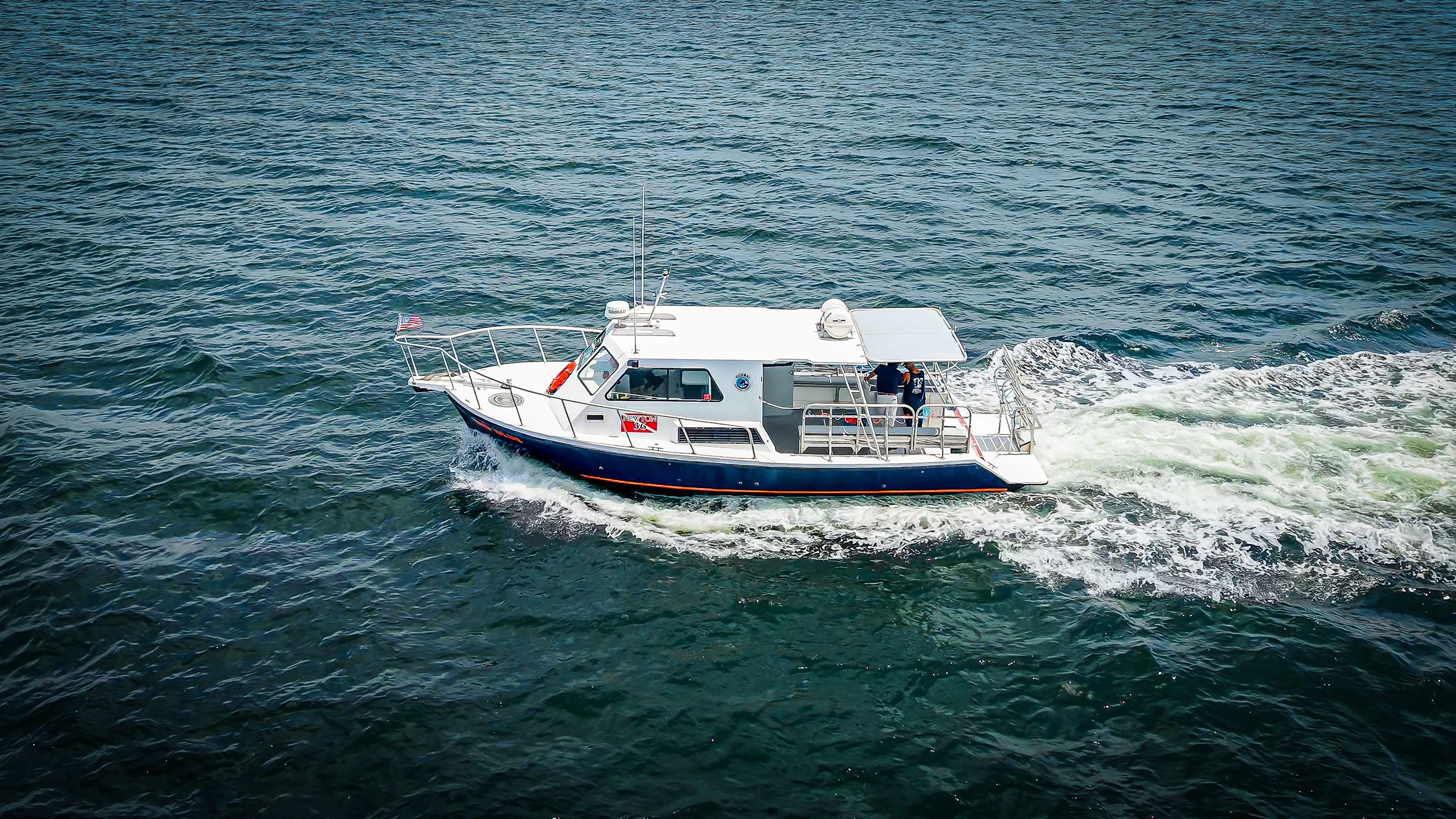 A 2019 Newton 36' Dive Special boat cruising on the water.
