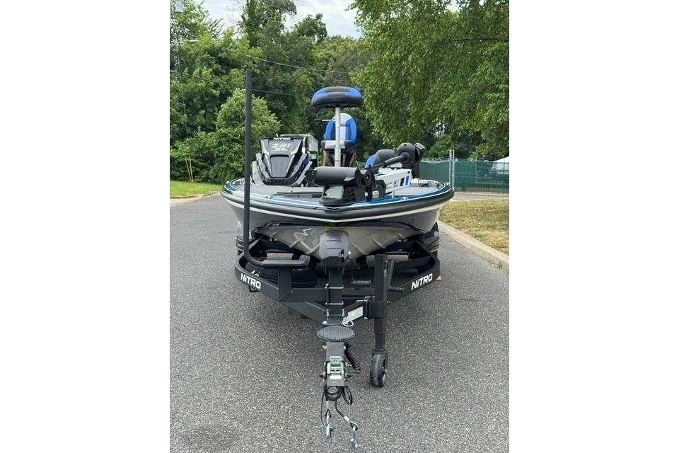 2026 Nitro Z21 XL boat on trailer, parked on a road with trees in background.
