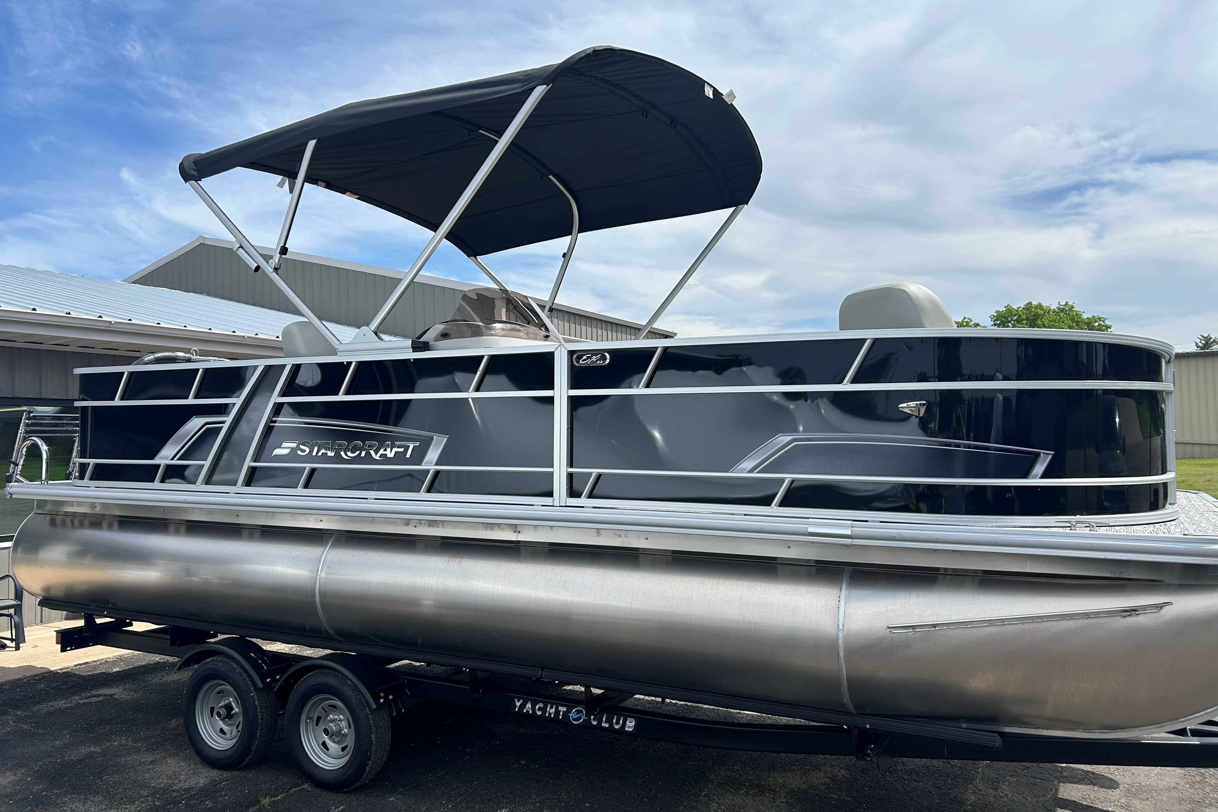 2026 Starcraft EX 22 FD pontoon boat with canopy on trailer, parked outdoors.