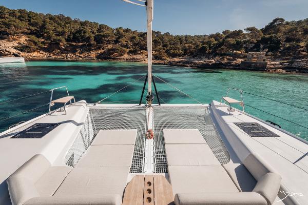 2025 Nautitech 44 Open catamaran in serene turquoise waters, featuring spacious deck and seating.