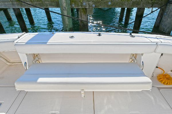 2008 Tiara Yachts 4200 Open, white bench seat, docked by wooden pier.