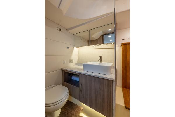 Manufacturer Provided Image: Modern bathroom in 2026 Regal 38 SAV yacht with sleek sink and wooden cabinetry.