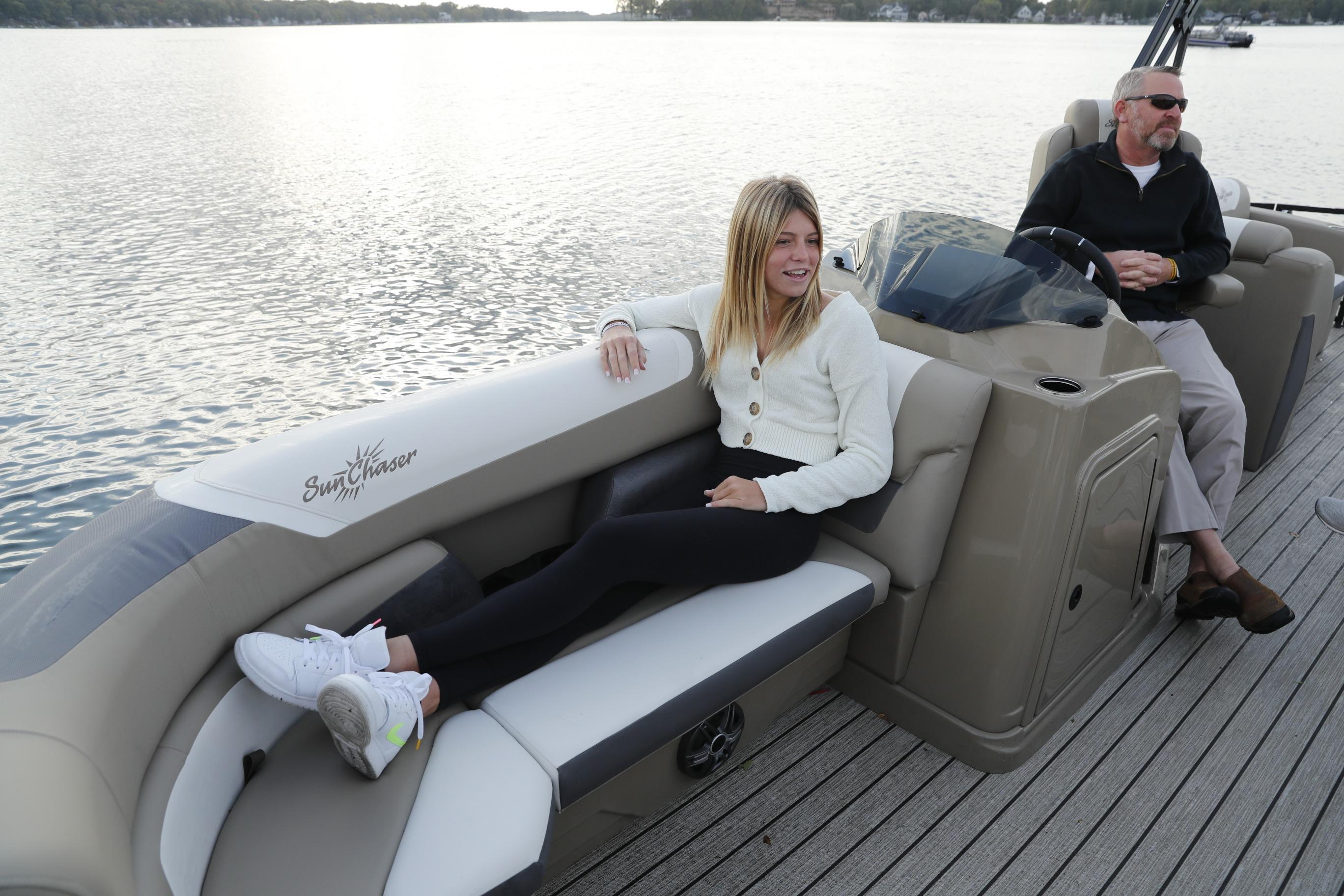 2026 SunChaser Eclipse 25 LR DH pontoon boat with passengers enjoying a serene lake view.
