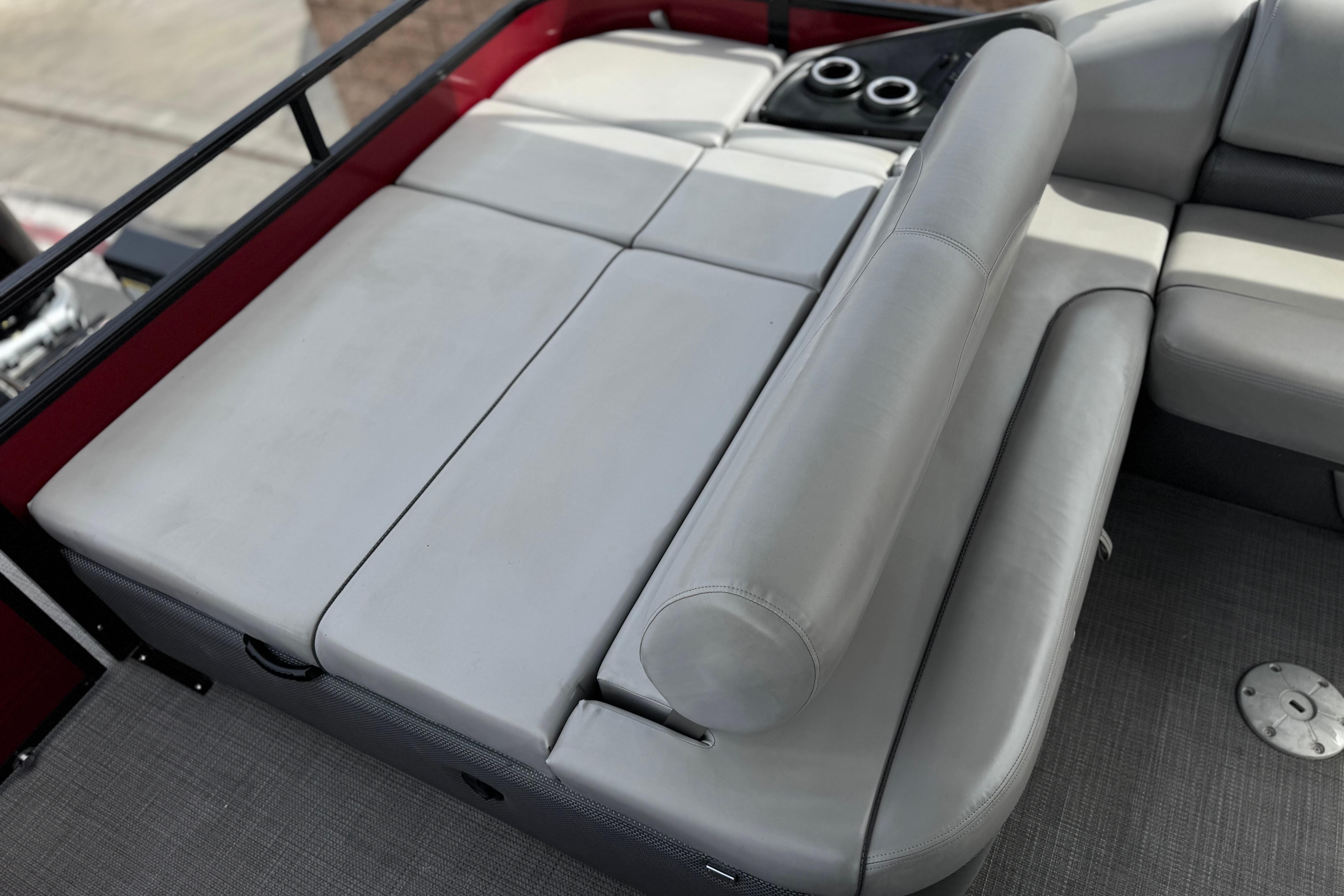 2022 Regency 250 DL3 boat interior with gray cushioned seating and cup holders.