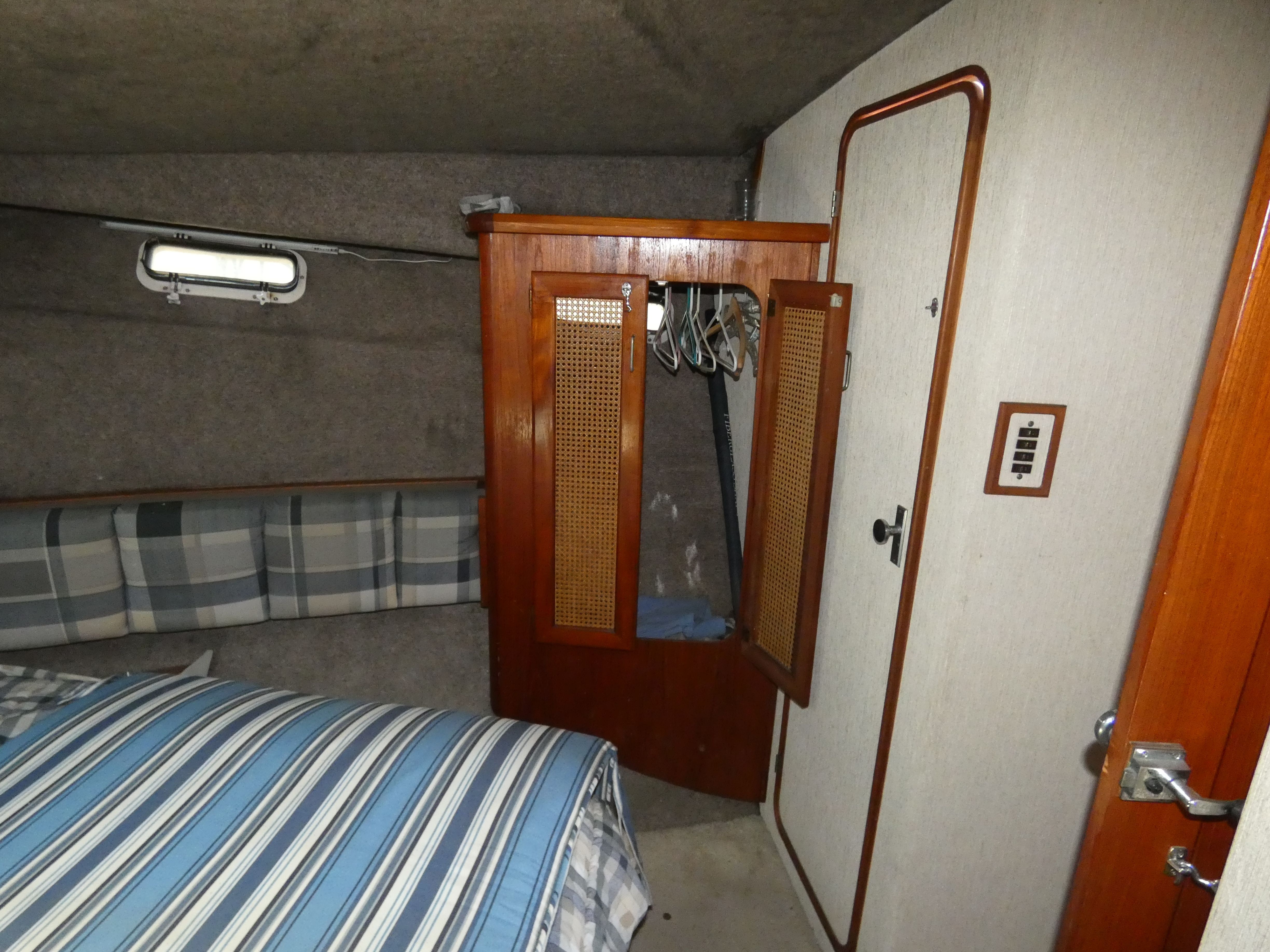 Interior of 1984 Bayliner 3870 Motoryacht with closet and bed.