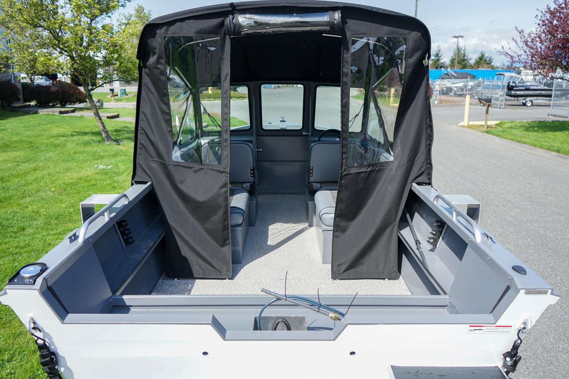 2026 Alumaweld Talon 18 boat interior with canopy, showcasing seating and storage.