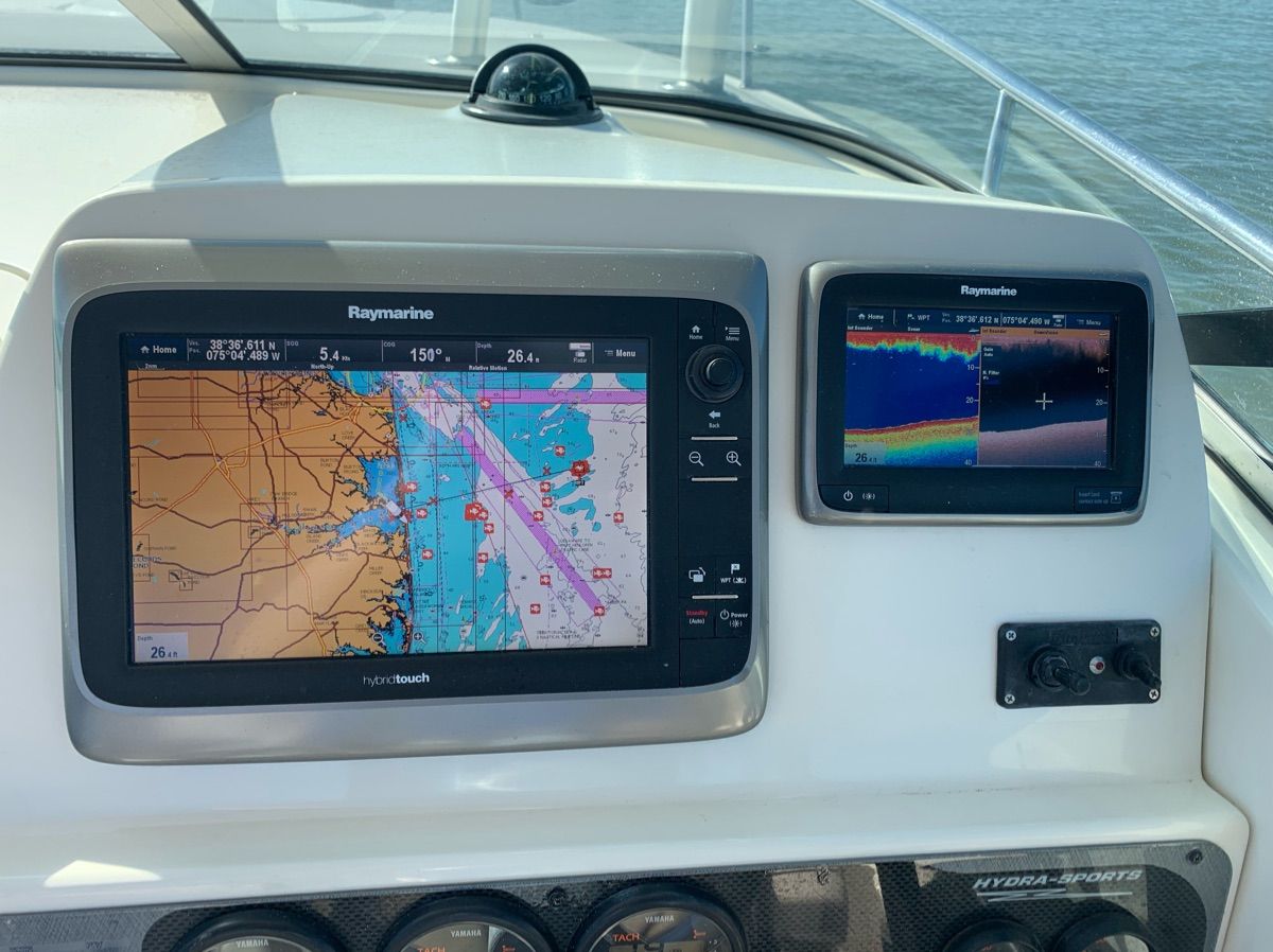 The dashboard of a Hydra-Sports Vector-VX boat with navigation screens.