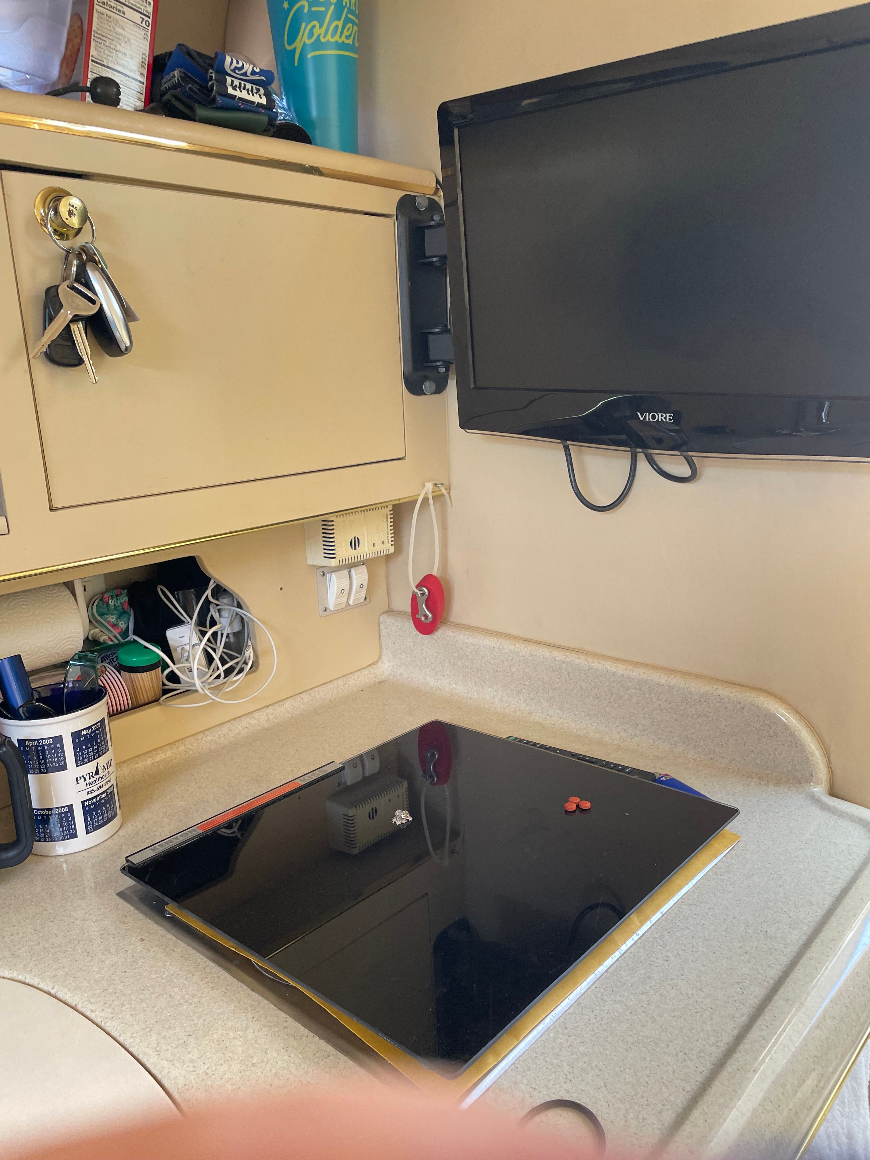 Interior of the Sea Ray 270 Sundancer with a TV and cabinet.