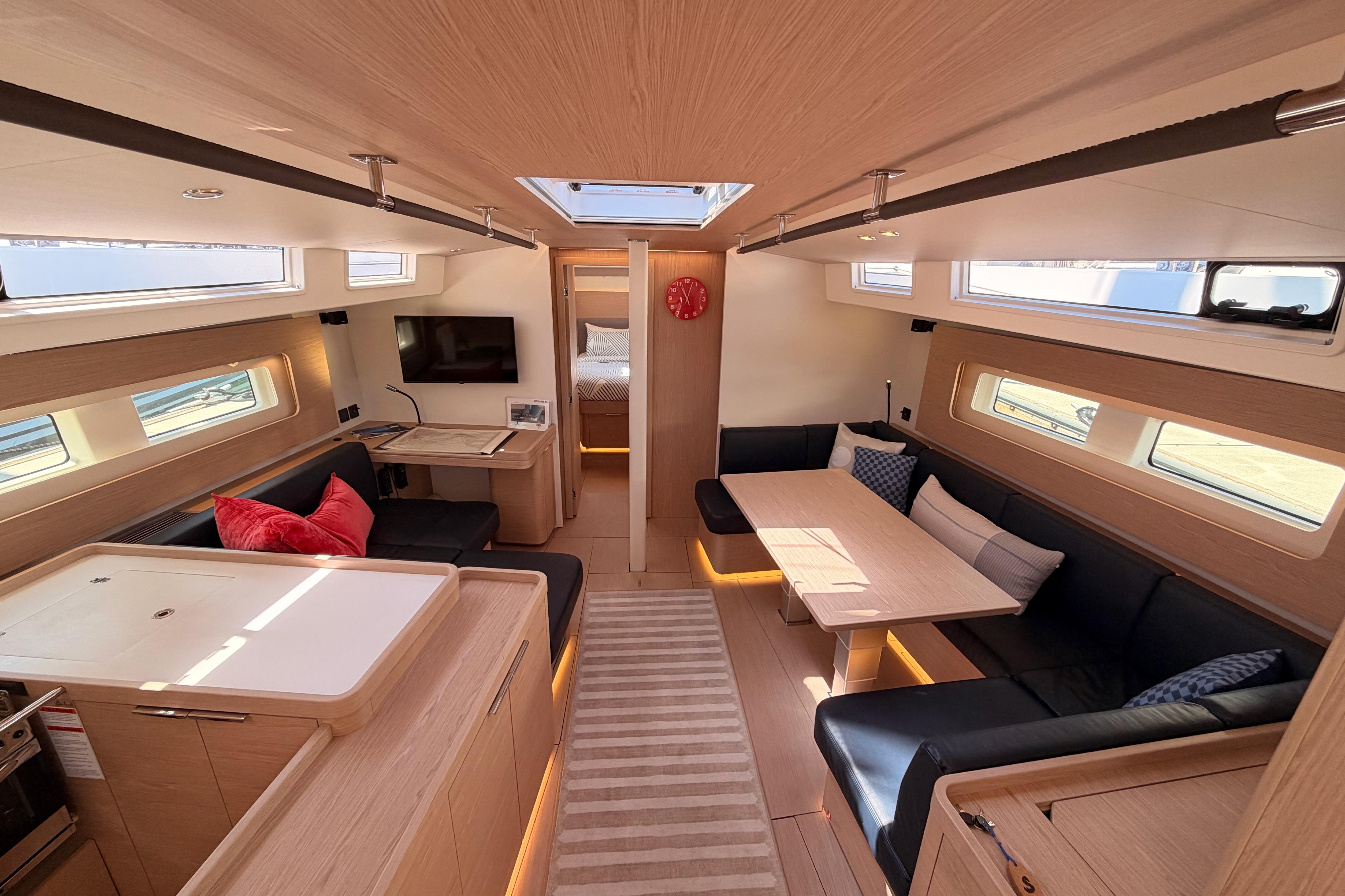 Luxurious interior of 2022 Beneteau Oceanis Yacht 54 with modern furnishings and ample natural light.