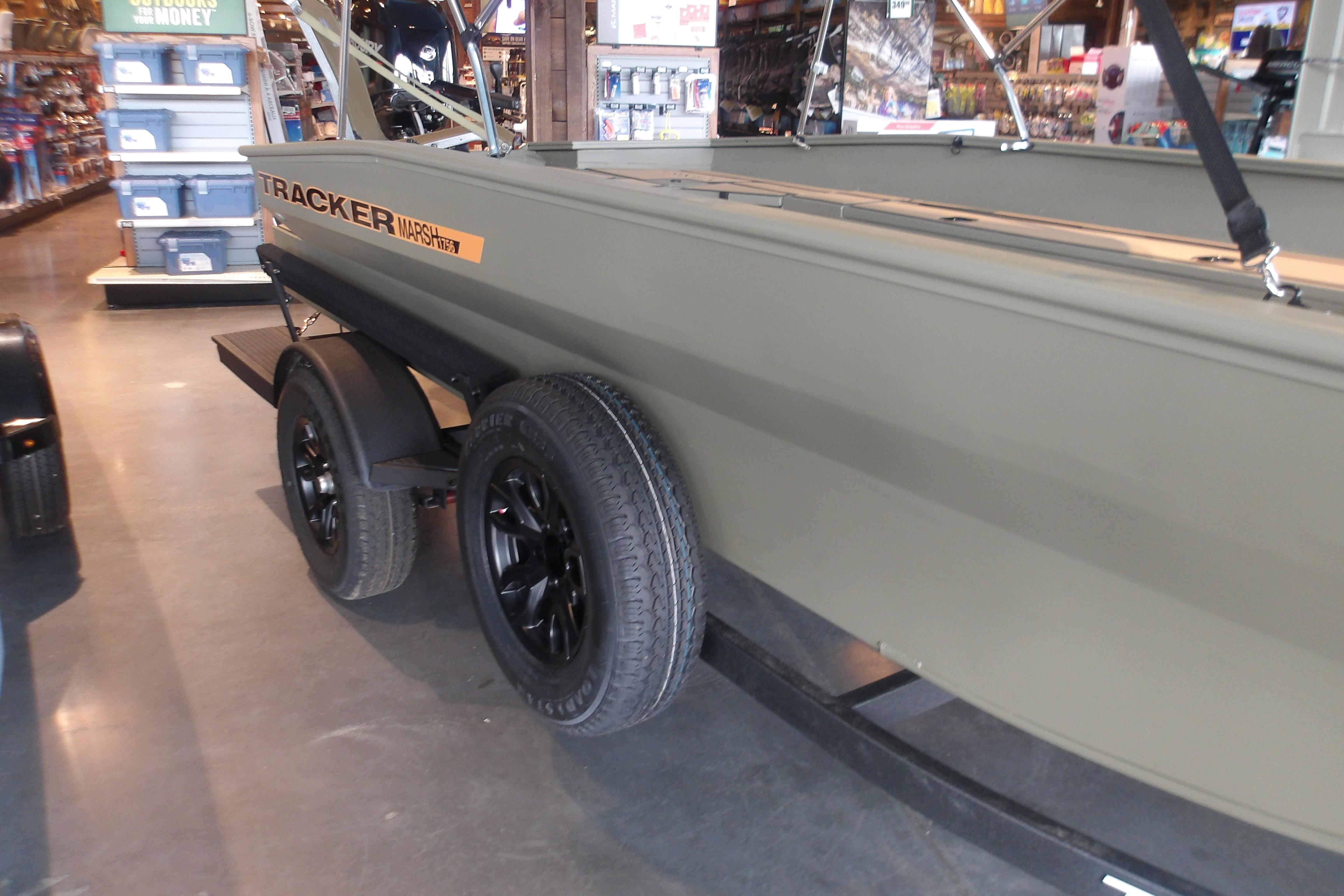 2026 Tracker Grizzly 1756 T Marsh boat on display in a store.