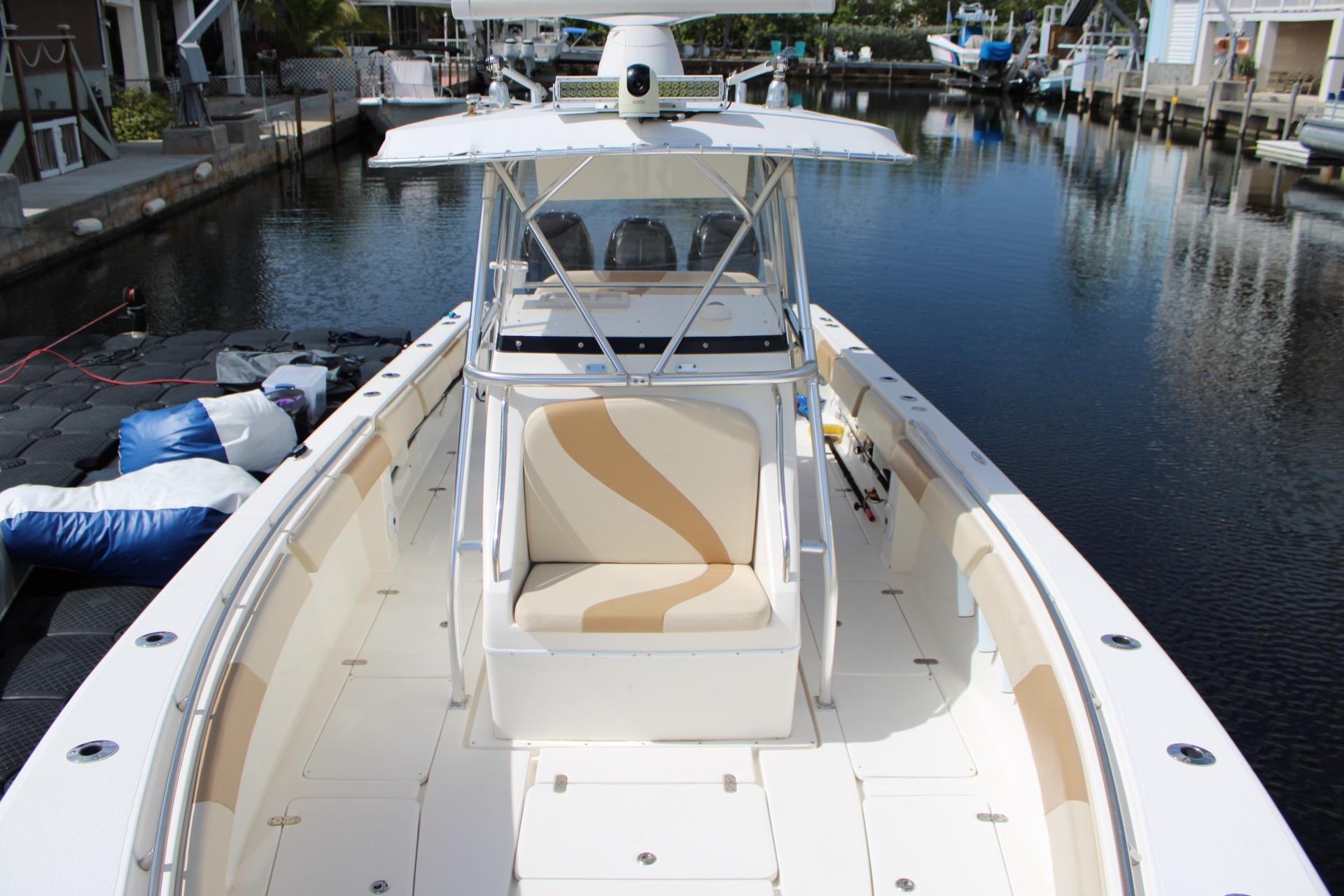 2007 Fountain 34 Center Console boat docked in a serene canal setting.