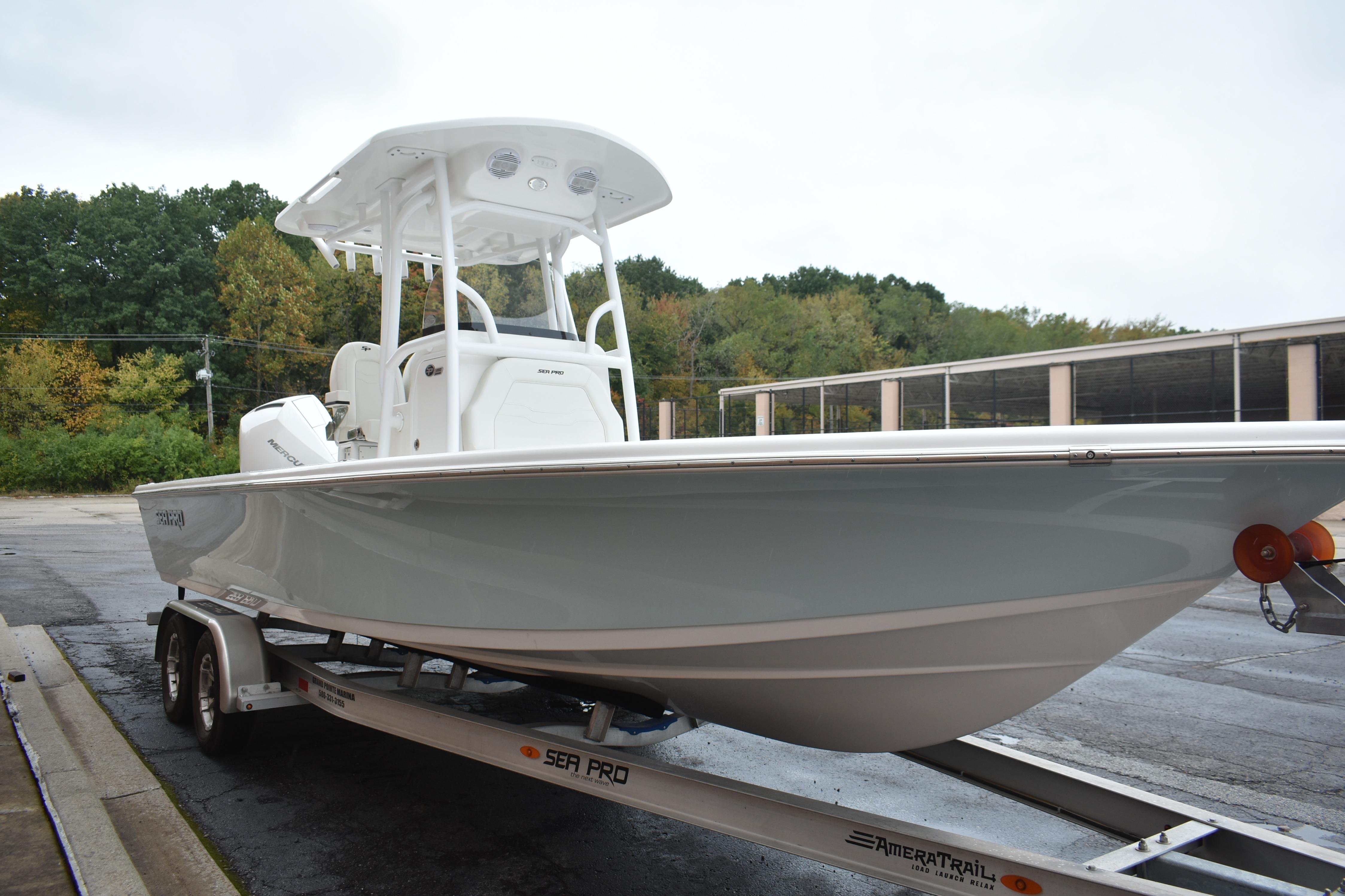 2025 Sea Pro 250 Bay boat on trailer, parked outdoors.