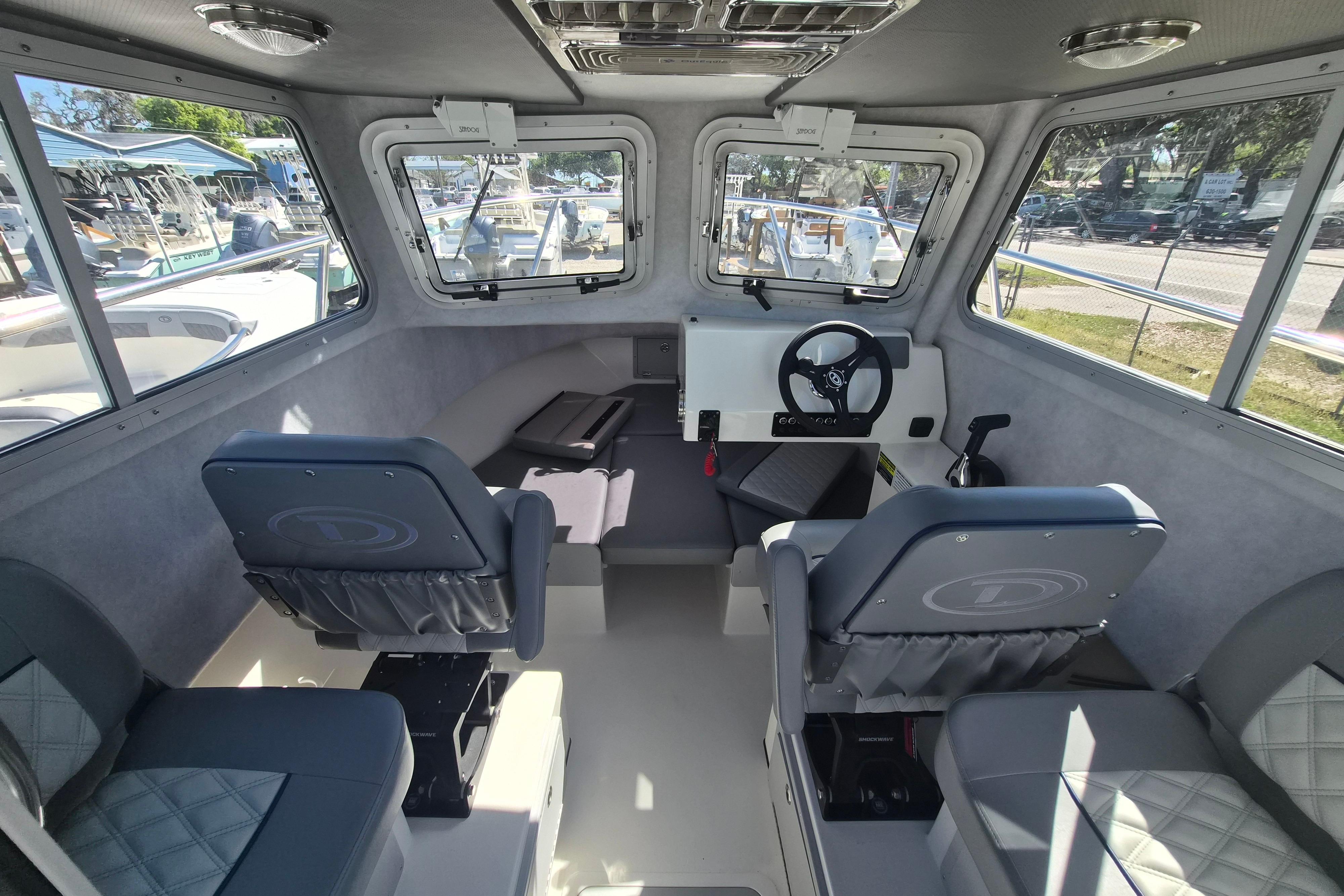 Interior of 2026 Defiance Admiral 220 EX boat with seating and steering wheel.