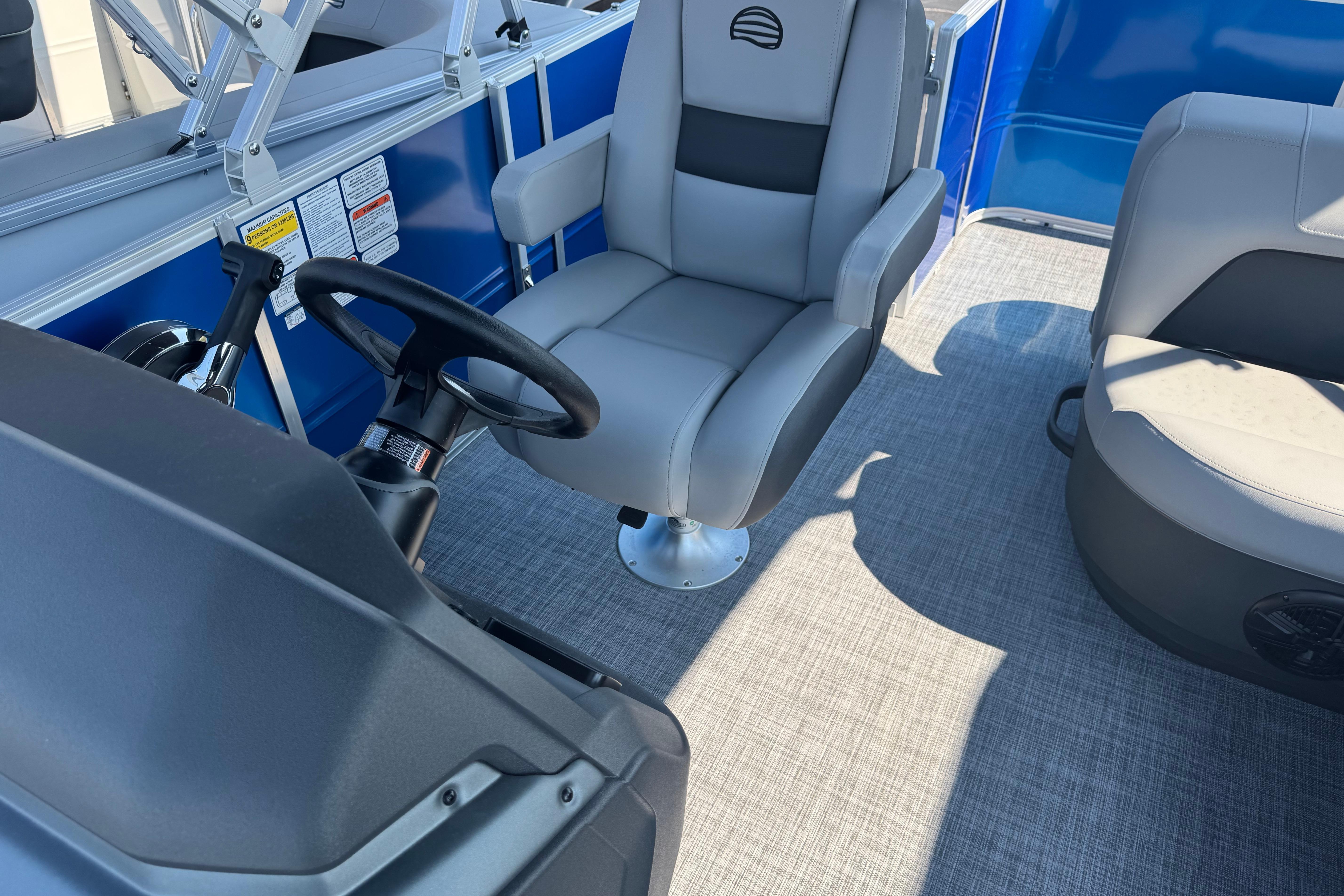 2026 Sun Tracker Party Barge 18 DLX interior with steering wheel and seating.