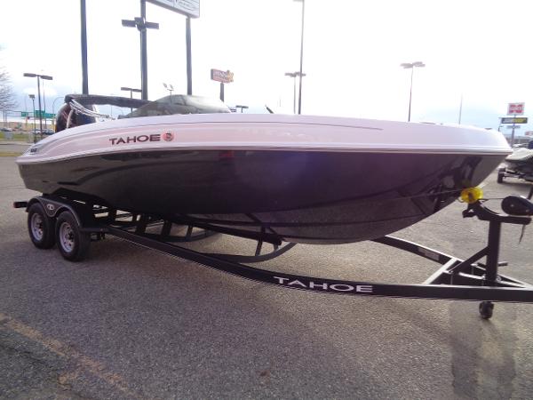 2024 Tahoe T21 boat on trailer in parking lot.