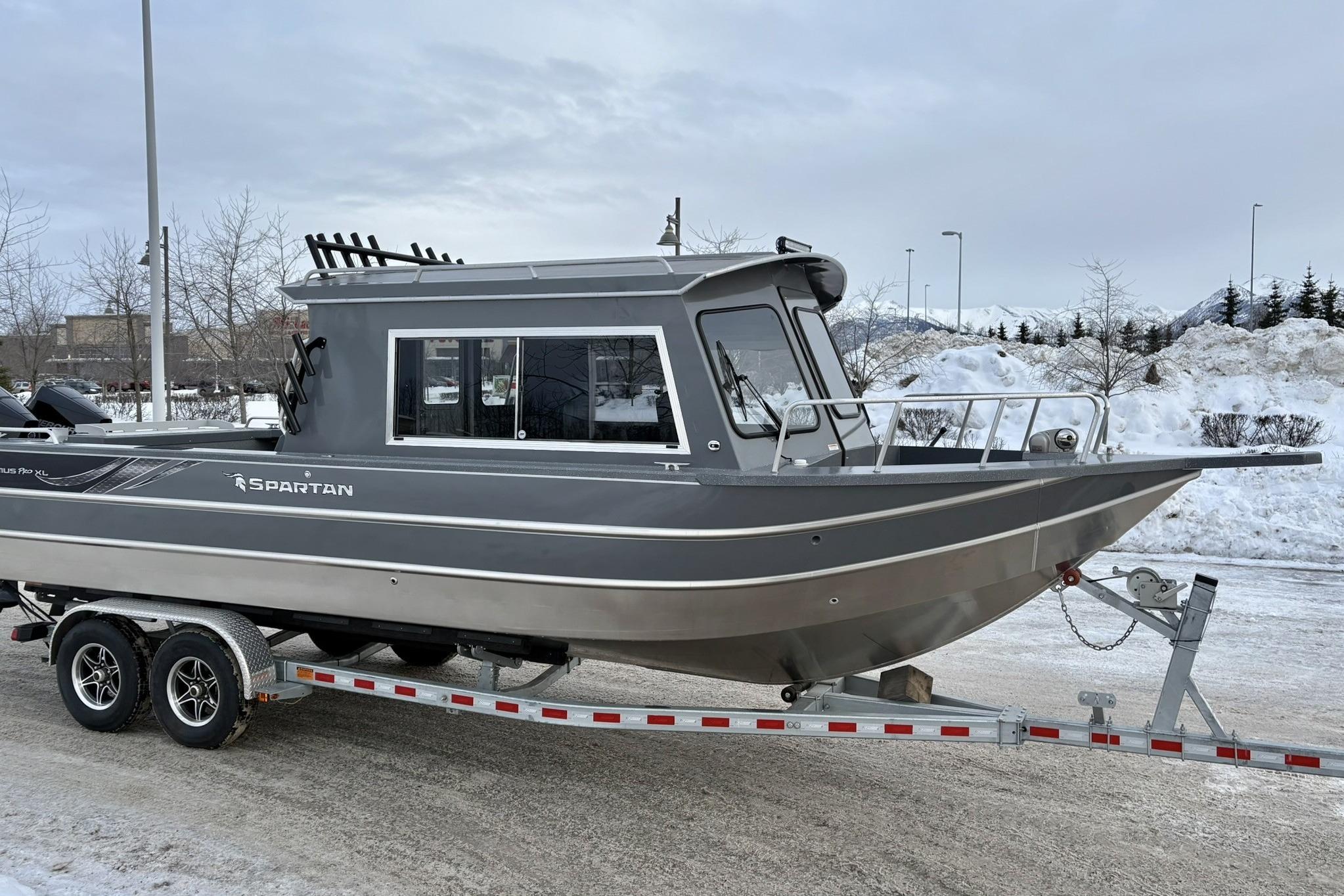 2024 Spartan 26 Maximus Pro XL boat on trailer in snowy landscape.