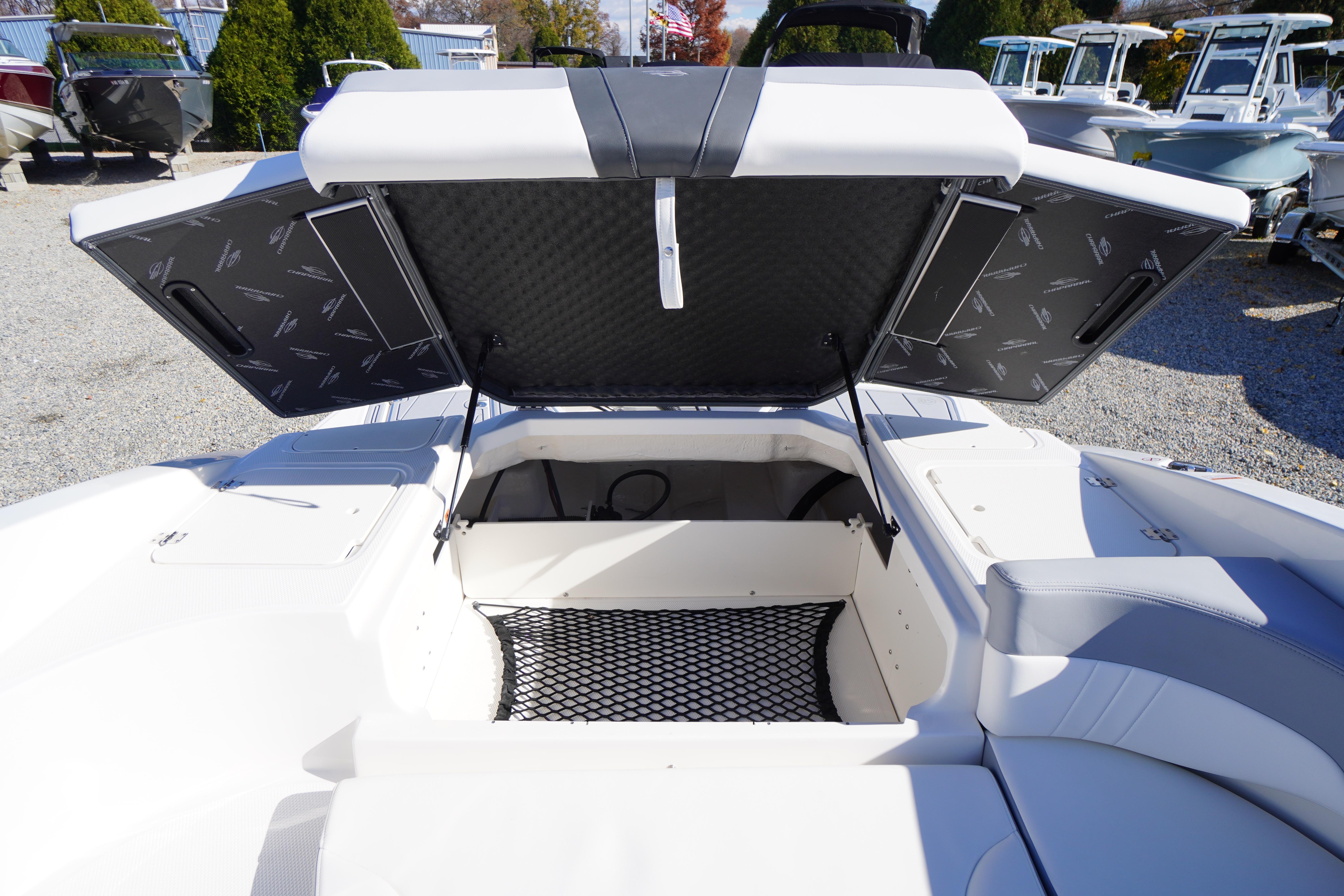 2026 Chaparral 23 SSi OB boat storage compartment with open hatch, showcasing spacious interior.