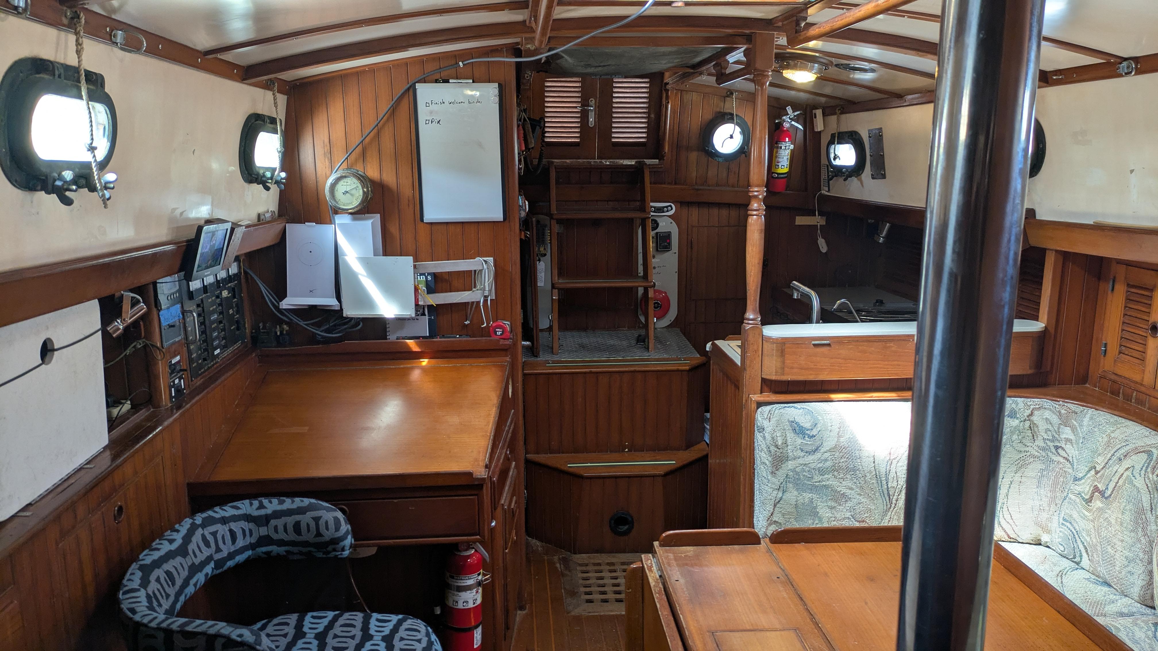 Interior of 1986 Tayana 37 sailboat with wooden furnishings and nautical decor.
